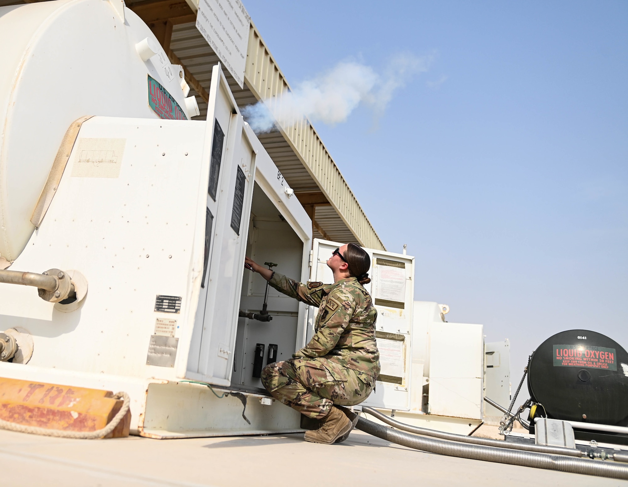 U.S. Air Force Senior Airman Morgan Garcia, a 379th Logistics Readiness Squadron petroleum oil lubricants specialist, vents a tank of liquid oxygen Aug 11, 2022 at Al Udeid Airbase, Qatar. Venting the tank allows POL Airmen to check the PSI and ensure the relief pressure is good to go. (U.S. Air National Guard photo by Master Sgt. Michael J. Kelly)