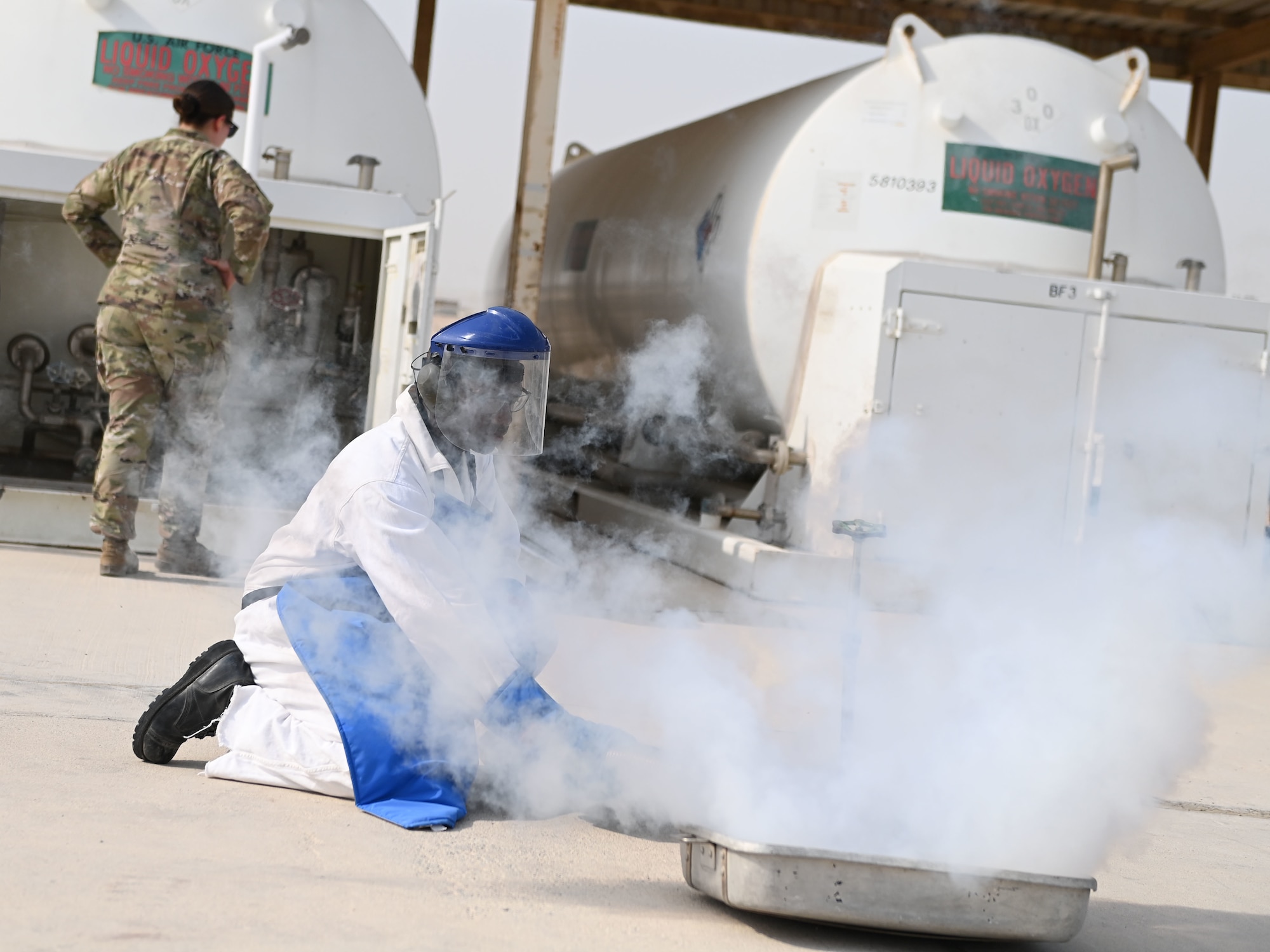 U.S. Air Force Senior Airman Dorian Longmire, a 379th Logistics Readiness Squadron petroleum oil lubricants specialist, purges a hose of liquid oxygen during a quality control test Aug 11, 2022 at Al Udeid Airbase, Qatar. Liquid oxygen is used in aircraft and breathing apparatus’s for aircrew. (U.S. Air National Guard photo by Master Sgt. Michael J. Kelly)