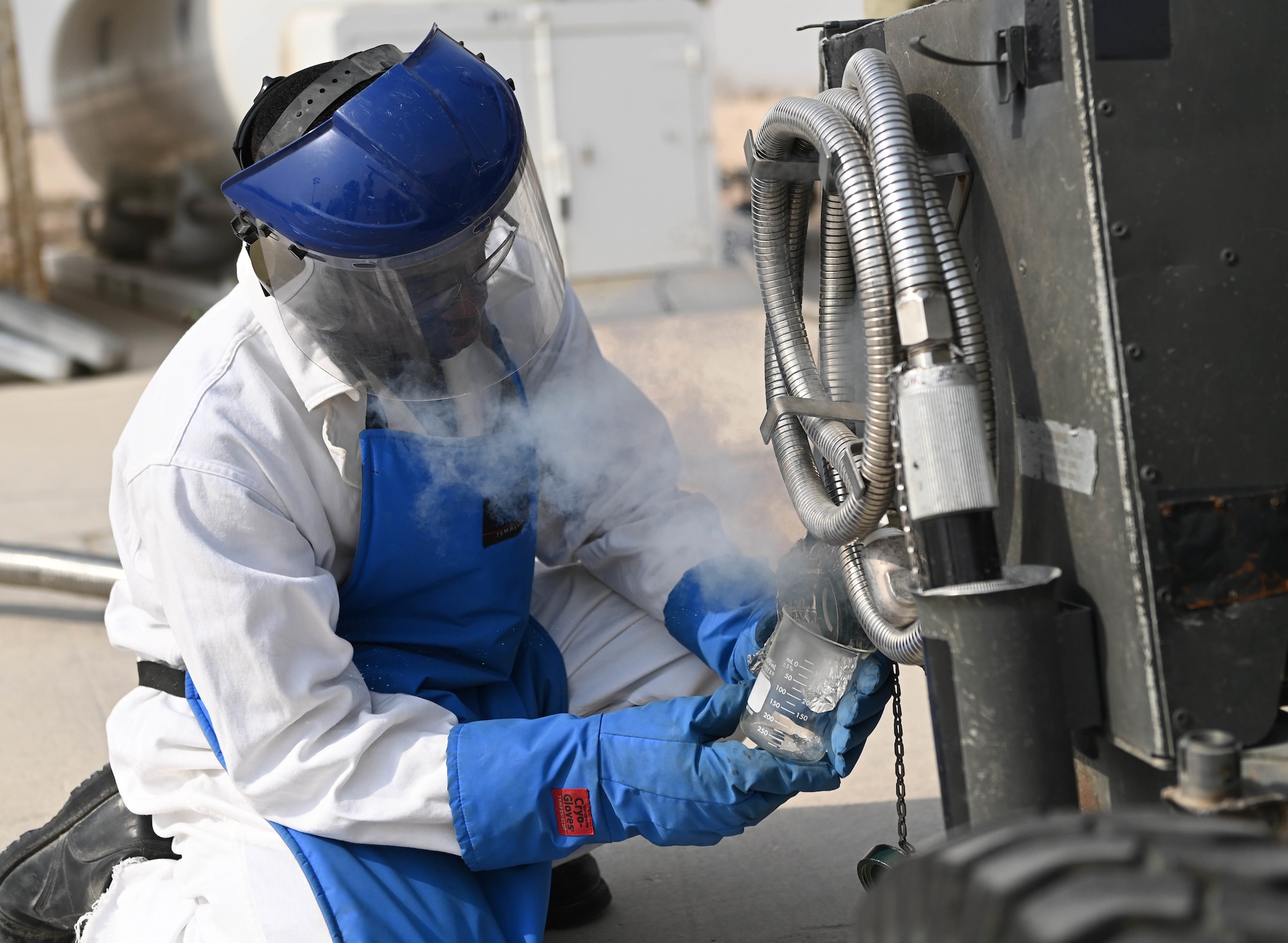 U.S. Air Force Senior Airman Dorian Longmire, a 379th Logistics Readiness Squadron petroleum oil lubricants specialist, conducts and quality control odor test of liquid oxygen Aug 11, 2022 at Al Udeid Airbase, Qatar. The 379th ELRS maintains and supplies liquid oxygen for the Air Forces Central (AFCENT) area of responsibility. (U.S. Air National Guard photo by Master Sgt. Michael J. Kelly)
