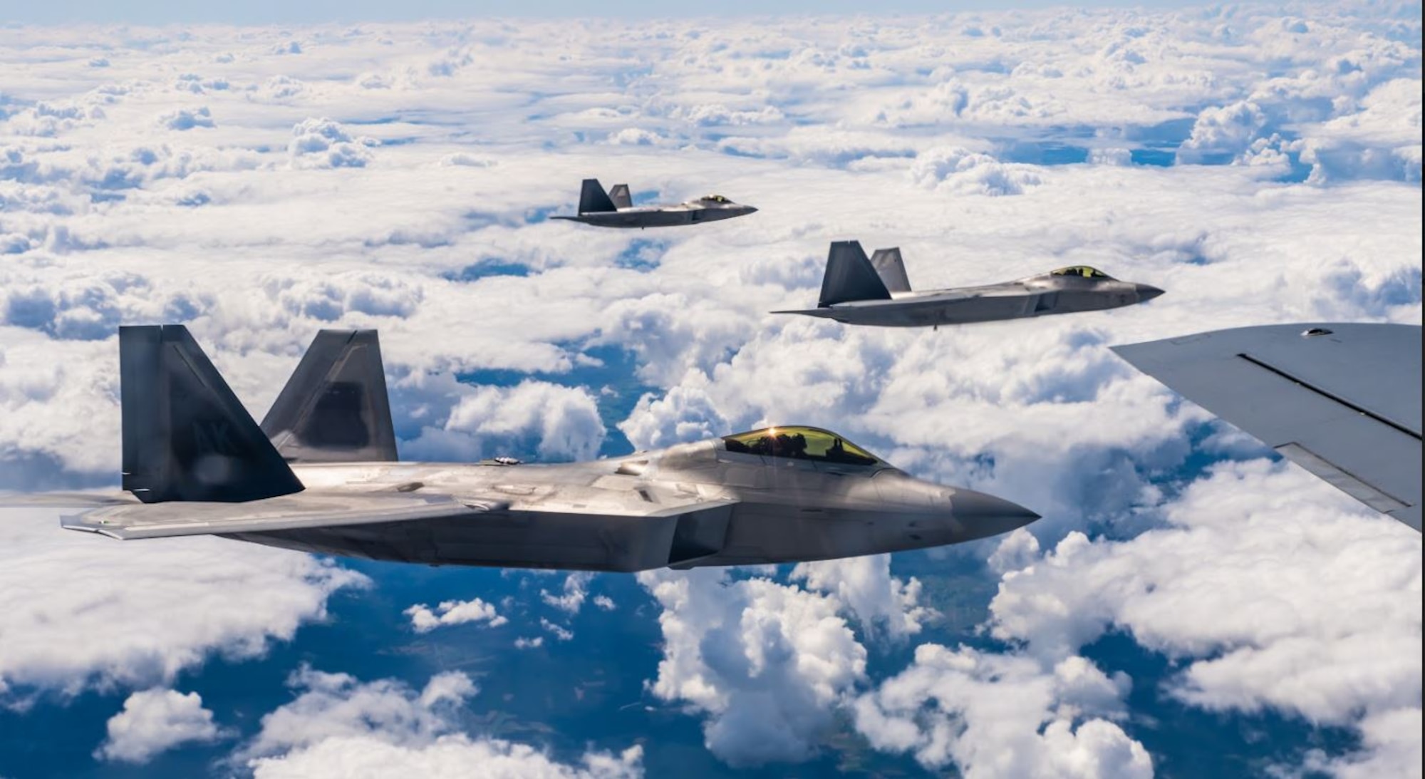 Three U.S. Air Force F-22 Raptor aircraft assigned to the 90th Fighter Squadron, Joint Base Elmendorf-Richardson, Alaska, fly alongside a U.S. Air Force KC-135 Stratotanker aircraft assigned to the 100th Air Refueling Wing at Royal Air Force Mildenhall, England, over Poland, Aug. 10, 2022. The F-22 possesses a sophisticated sensor suite allowing the pilot to track, identify, shoot and kill air-to-air threats before being detected. It cannot be matched by any known or projected fighter aircraft, making it a highly strategic platform to support NATO Air Shielding. (U.S. Air Force photo by Staff Sgt. Kevin Long)