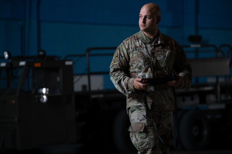 U.S. Air Force 1st Lt. Andrew Cuccia chief innovation officer, operates a Ghost Robotics, Vision 60 Quadruped Unmanned Ground Vehicle (Q-UGV) with a handheld controller at Cape Canaveral Space Force Station, Fla., July 27, 2022. The Q-UGV will be used for damage assessments and patrol to save significant man hours. (U.S. Space Force photo by Senior Airman Samuel Becker)