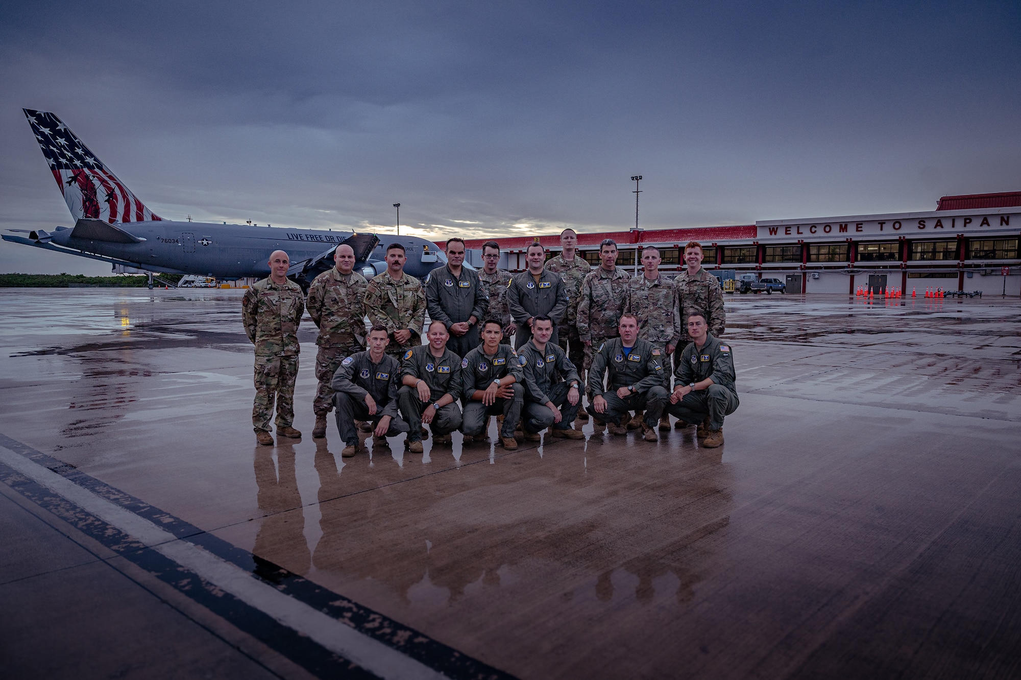 A group of Airmen assigned to the 157th Air Refueling Wing, pose for a photograph in front of a KC-46 Pegasus at Saipan International Airport. The group flew to Saipan aboard the KC-46 as part of the Super Sortie endurance exercise, Aug. 7, 2022.