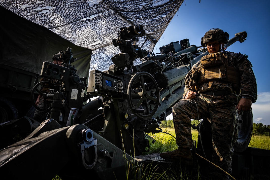 U.S. Marines with 2d Battalion, 10th Marine Regiment, 2d Marine Division, prepare to fire an M777 Howitzer during Exercise Hide and Seek on Camp Lejeune, North Carolina, July 27, 2022. Hide and Seek is a true force-on-force exercise in which participating forces thoroughly test and document tactics, techniques and procedures for observation in the information environment in support of expeditionary advanced base operations and stand-in forces. (U.S. Marine Corps photo by Lance Cpl. Ethan Robert Jones)