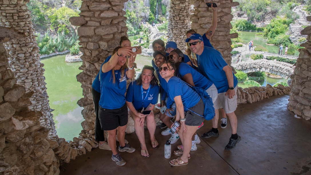 Caregivers pose for a group photo in a Japanese Tea Garden.