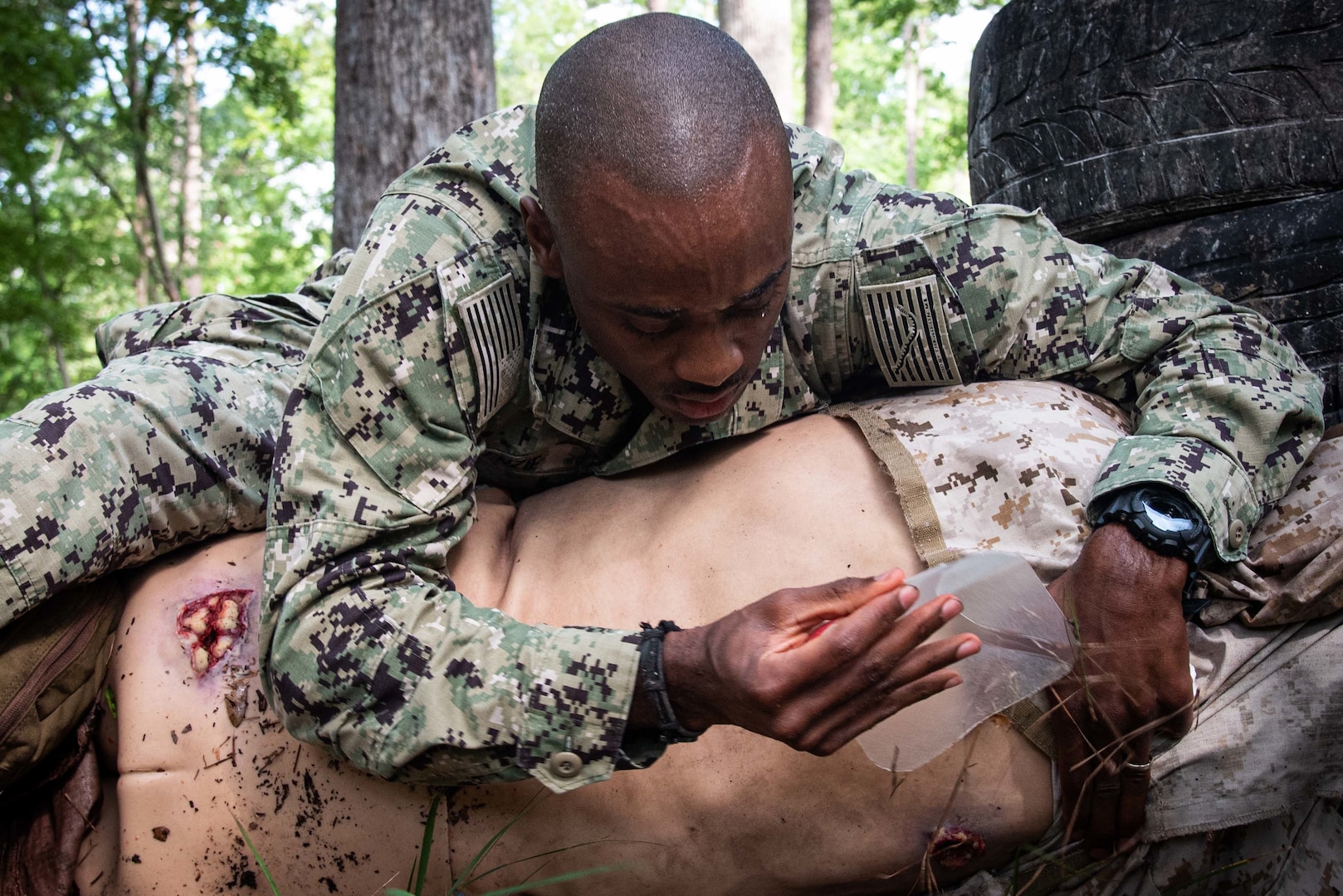 *TRAINING*TRAINING*TRAINING* Hospital Corpsman First Class Clement McKenzie applies a chest seal to treat an exit wound on a mannequin during a training event held August 4 aboard Marine Corps Air Station Cherry Point.  Clement and other sailors assigned to Naval Health Clinic Cherry Point conducted the practical exercise as students in Tactical Combat Casualty Care, a course designed to sharpen their battlefield medicine skills.