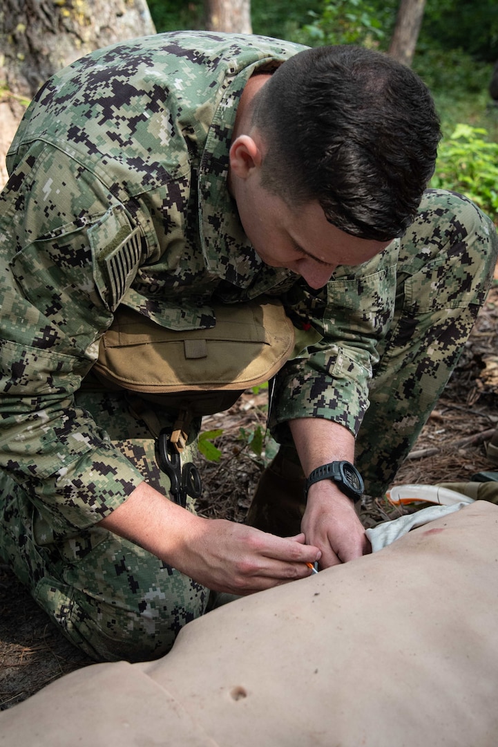 *TRAINING*TRAINING*TRAINING* Hospitalman Charles Fox treats a mannequin for tension pneumothorax during a training event held August 4 aboard Marine Corps Air Station Cherry Point.  Fox and other sailors assigned to Naval Health Clinic Cherry Point conducted the practical exercise as students in Tactical Combat Casualty Care, a course designed to sharpen their battlefield medicine skills.