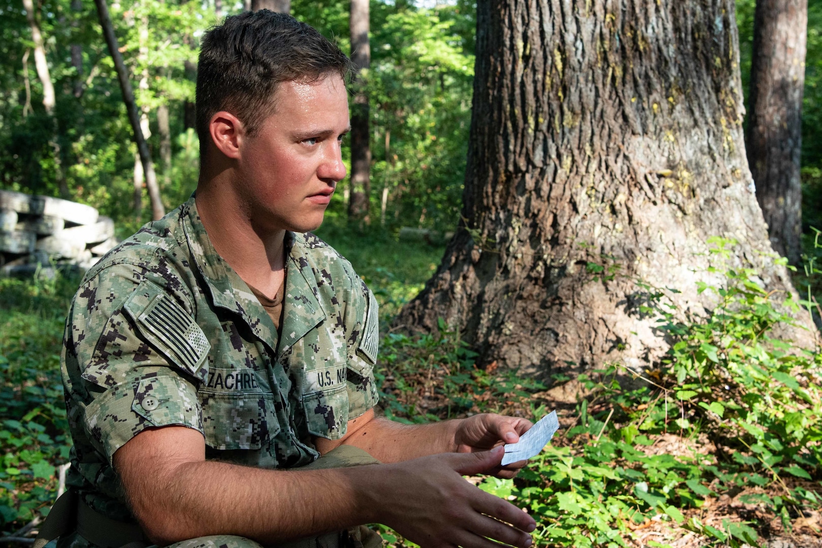 Hospital Corpsman Third Class Nathan Zachreaus answers an instructor’s questions about administering medical care during a training event held August 4 aboard Marine Corps Air Station Cherry Point.  Zachreaus and other sailors assigned to Naval Health Clinic Cherry Point conducted the practical exercise as students in Tactical Combat Casualty Care, a course designed to sharpen their battlefield medicine skills.