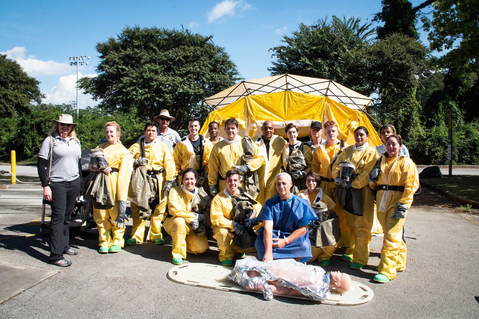 The Naval Health Clinic Cherry Point Decontamination Team pauses for a photo with their training staff Thursday, October 14 aboard Marine Corps Air Station Cherry Point.  Sailors assigned to the team participated in a multi-day training program to sharpen their skills at safely removing hazardous materials from patients.