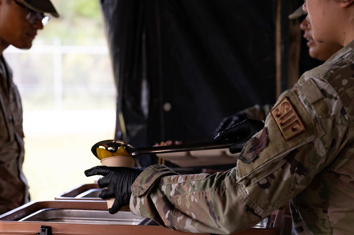 Photo Airman from the 23d Logistics Support Squadron prepares a meal