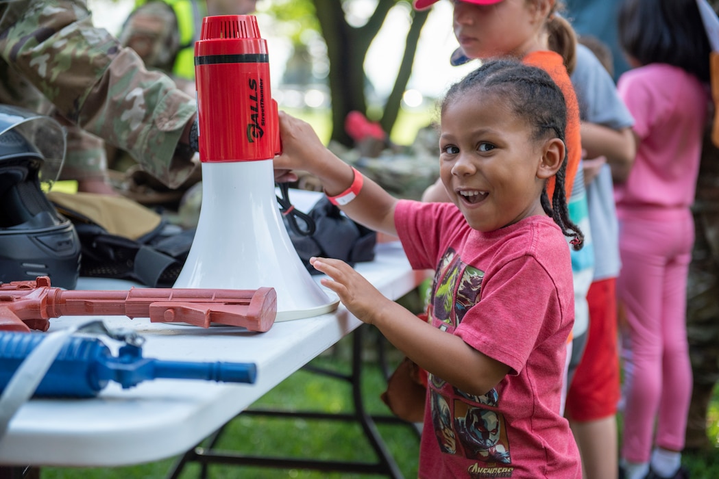 Child looks at Security Forces equipment at the Kids Understanding Deployment Operations.