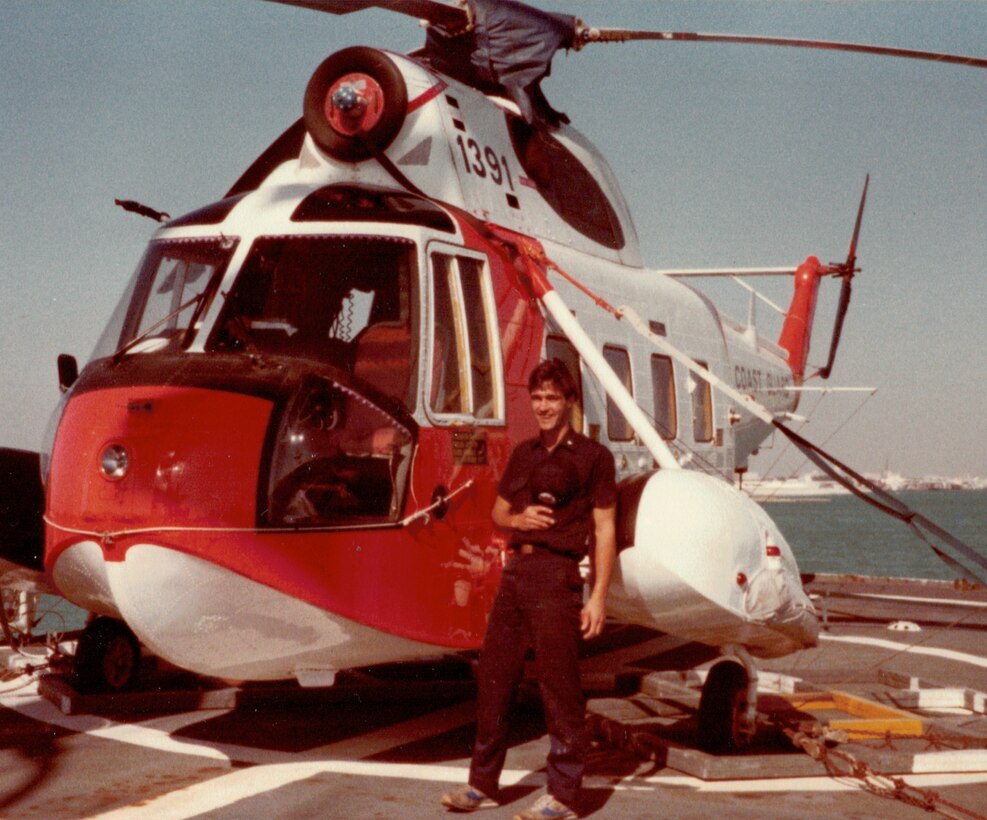 AM2 Dave Moynihan, USCG, stands beside  his creation -- the HH-52 "Love Ma'chine" he "converted" aboard USCGC Alert off Nassau, Bahamas, March, 1981.