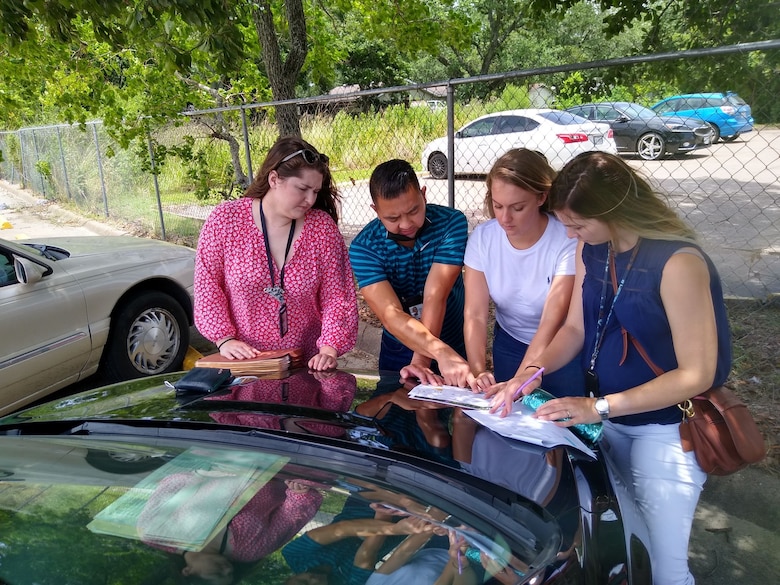 Kelsey Ciarrocca (second from right), a cartographer with the U.S. Army Corps of Engineers (USACE) Galveston District, points out properties on a map before conducting rights-of-entry (ROE) visits in a south Texas neighborhood. 


Ciarrocca’s work involves supporting project delivery teams—made up of USACE staff and contractors—who do most of their work out in the field. This includes a lot of going door-to-door securing critical ROEs from private landowners to access properties. Without the ROEs, the Real Estate Division can’t conduct important surveys and geotechnical investigations.