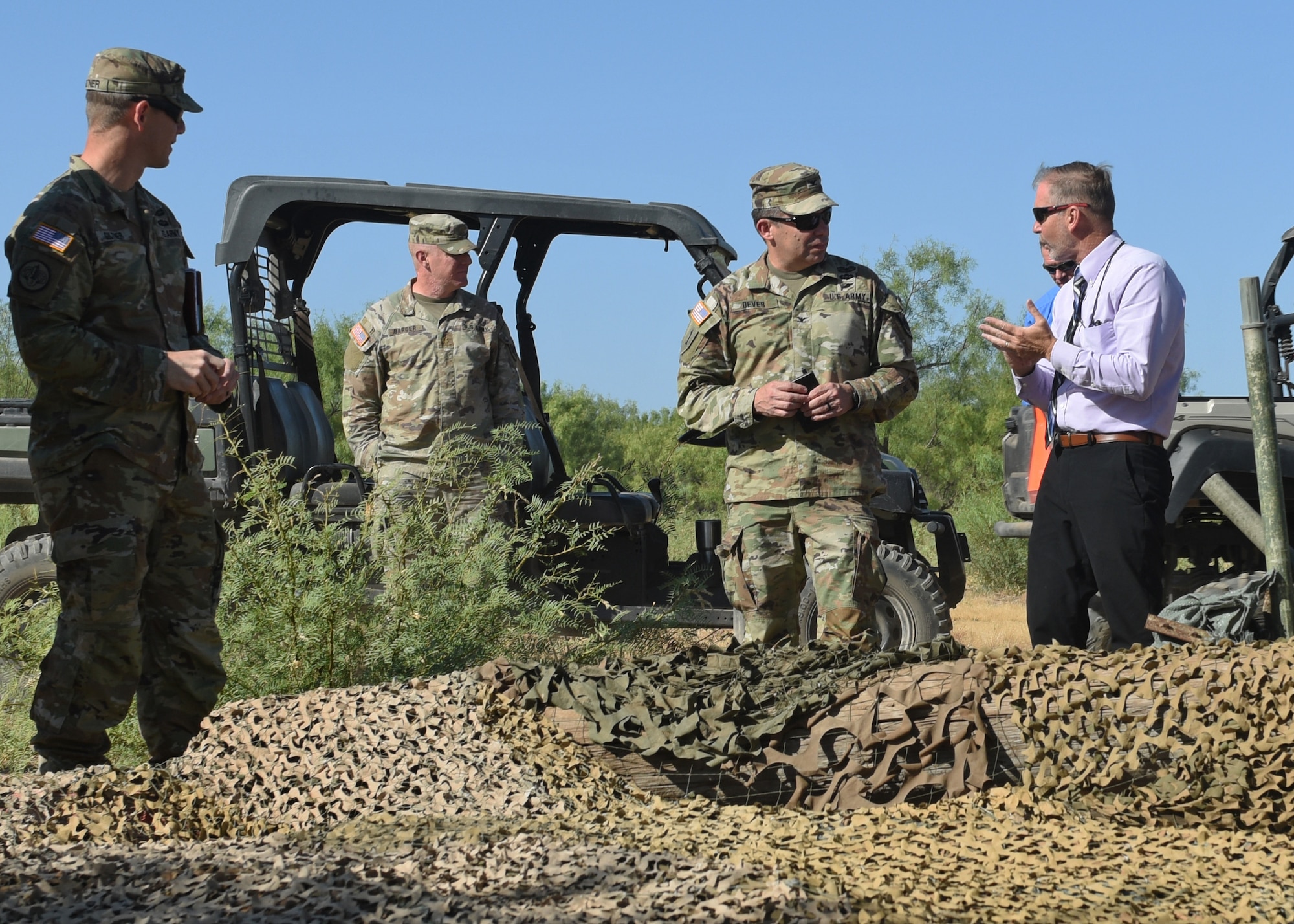 U.S. Army Col. Brendon Dever, 111th Military Intelligence Brigade commander, surveys a fox hole during a tour of Forward Operating Base Sentinel, at Goodfellow Air Force Base, Texas, August 9, 2022. FOB Sentinel serves as the 344th Military Intelligence Battalion’s signals intelligence capstone exercise where students apply their skills learned throughout their training in a simulated combat environment. (U.S. Air Force photo by Airman 1st Class Zachary Heimbuch)