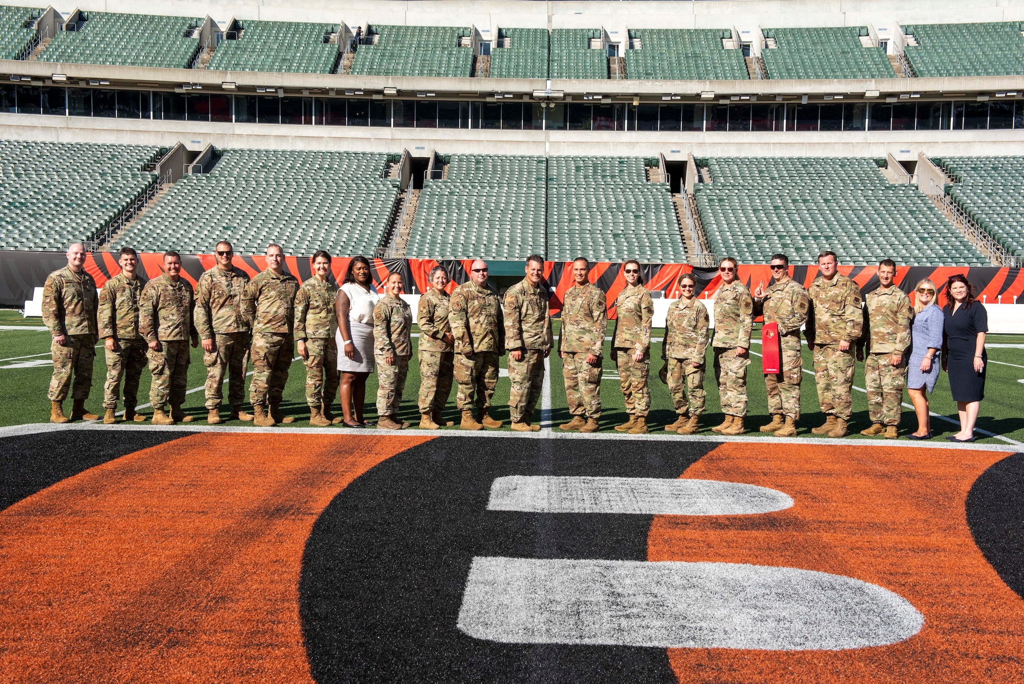 Airmen pose for a photo with Bengals front office staffers.