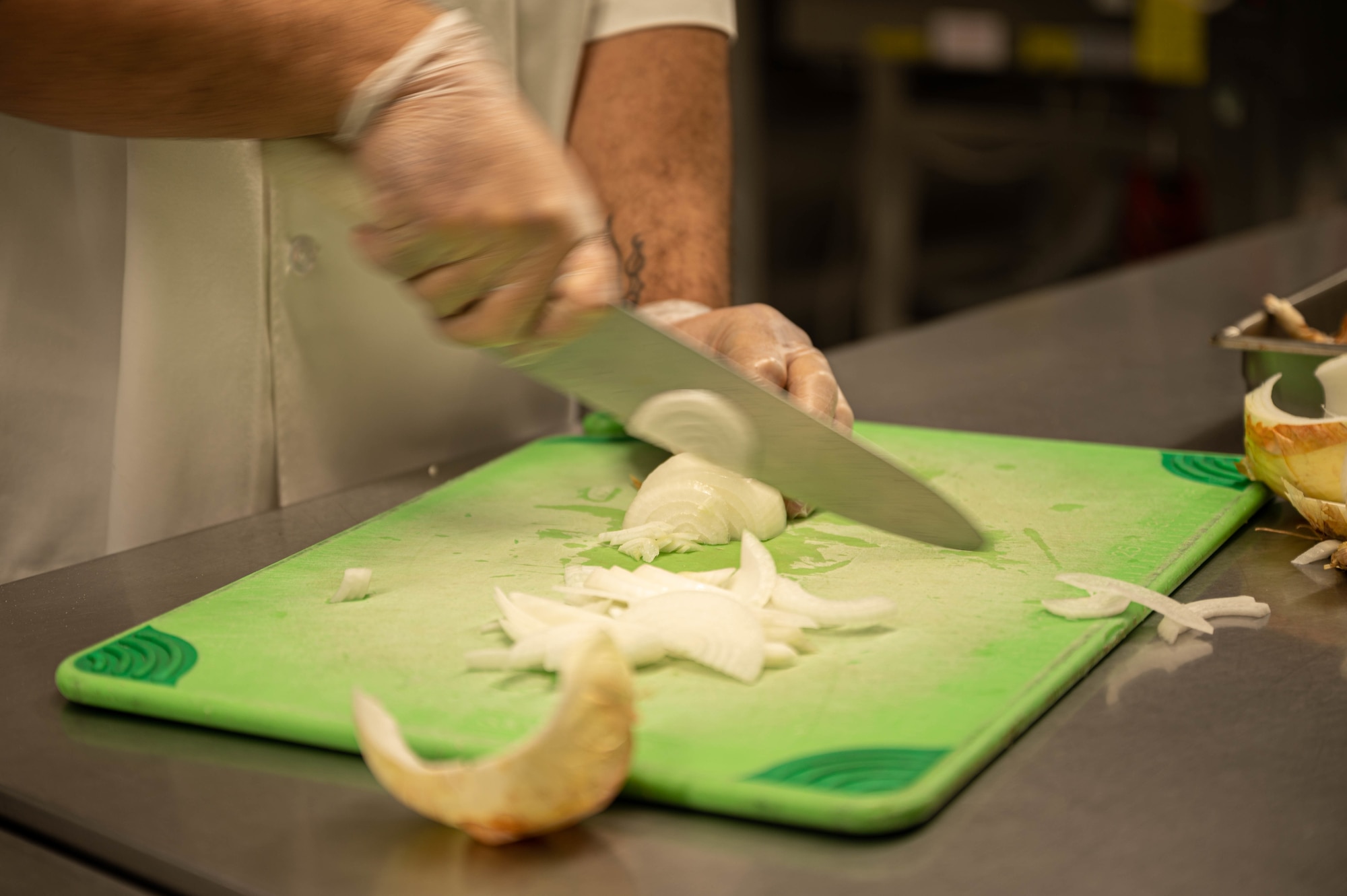 Airman chops onions.