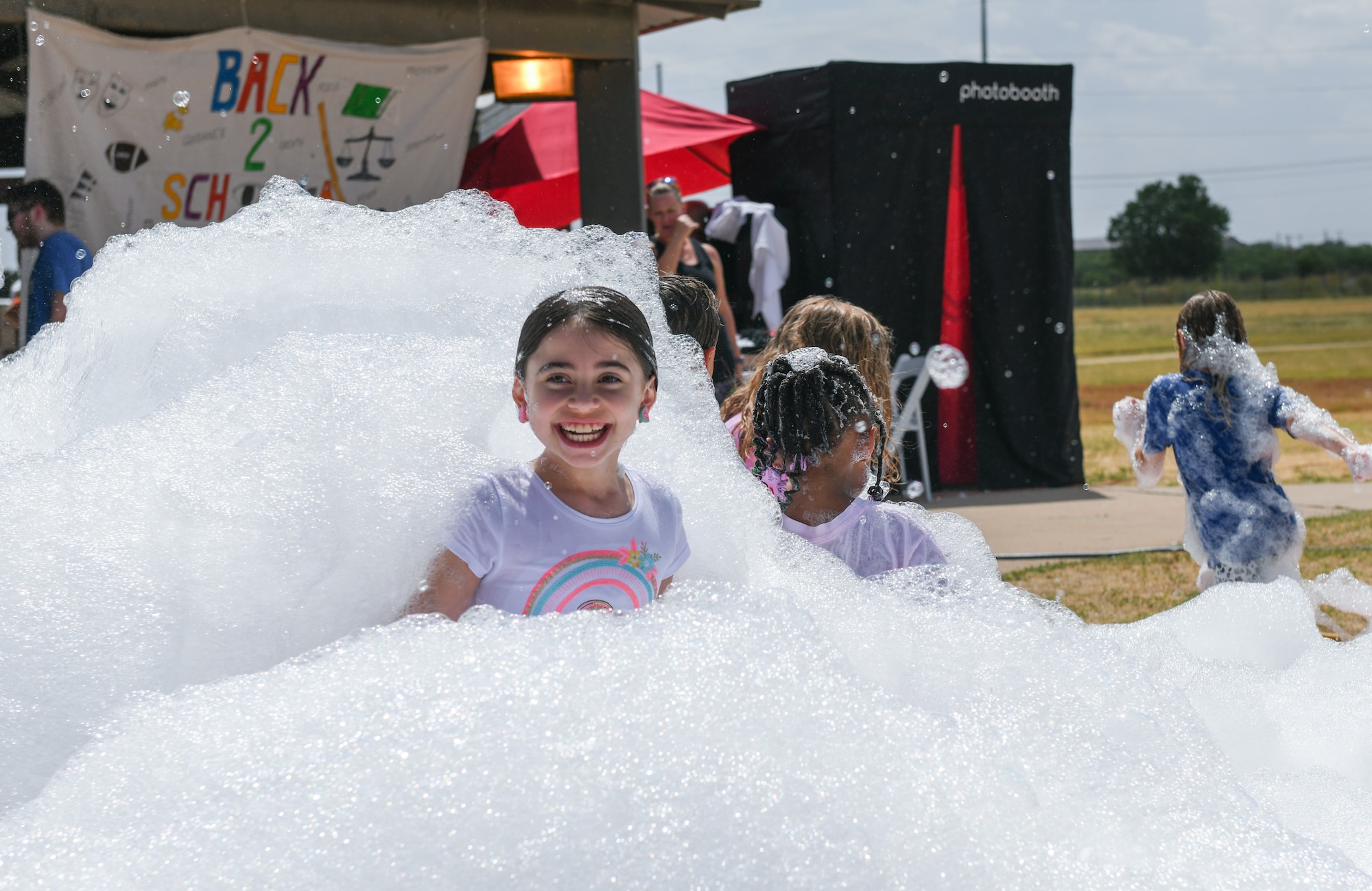 Children of 97th Air Mobility Wing Airmen play in foam at the “Back to School-A-Palooza” at Altus Air Force Base, Oklahoma, Aug. 5, 2022. More than 400 people attended the event. (U.S. Air Force photo by Airman 1st Class Miyah Gray)