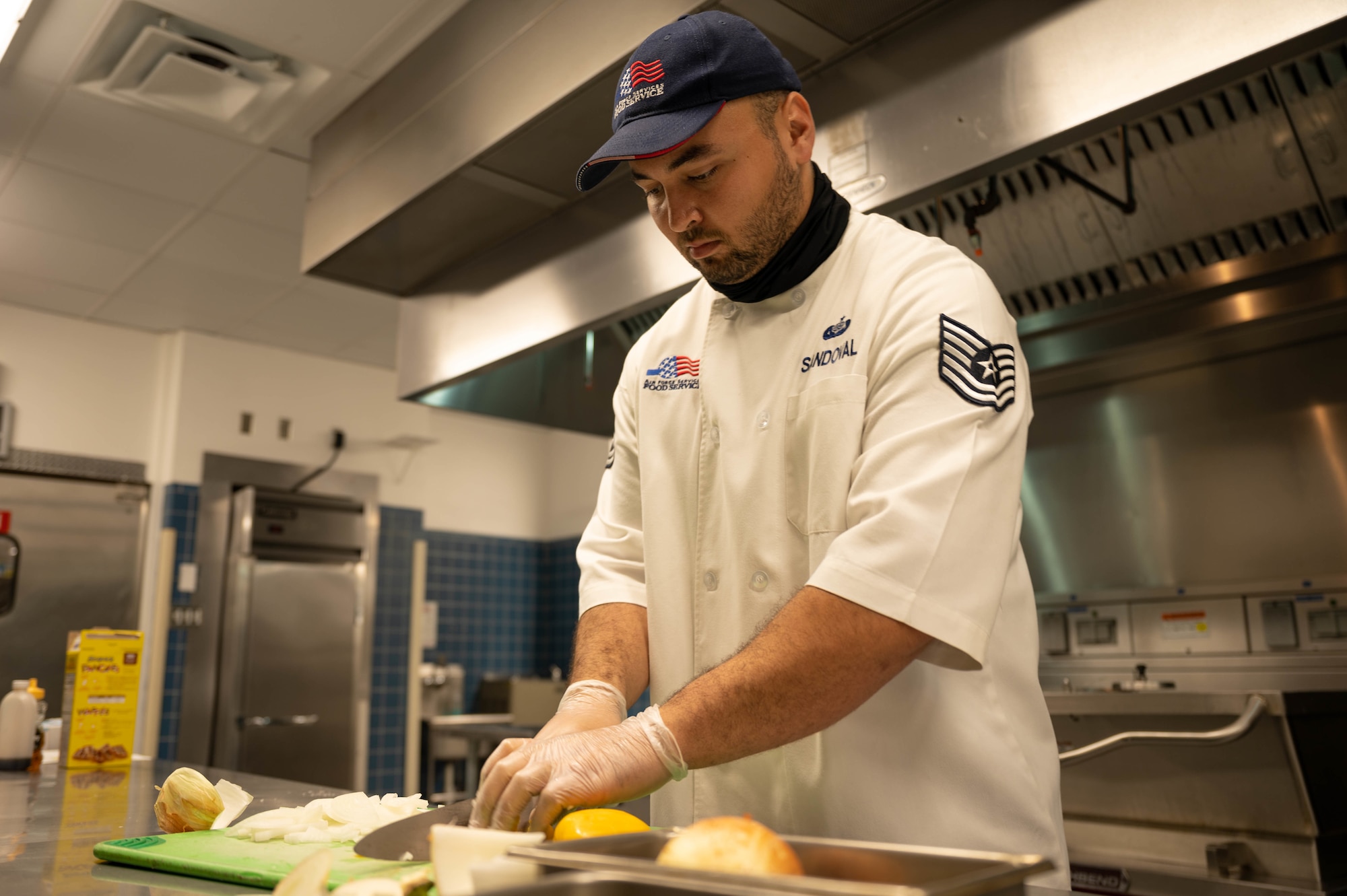 Airman chops onions.