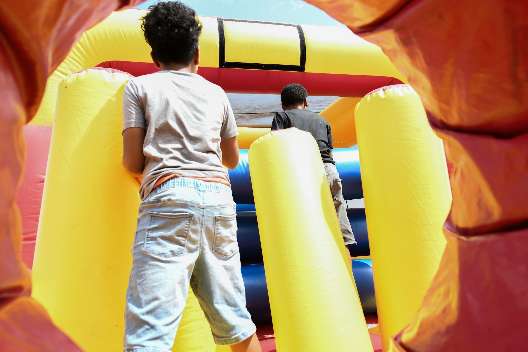 Children of 97th Air Mobility Wing Airmen play in a bounce house at the “Back to School-A-Palooza” at Altus Air Force Base, Oklahoma, Aug. 5, 2022. The event provided free school supplies to children and anyone with base access. (U.S. Air Force photo by Airman 1st Class Miyah Gray)