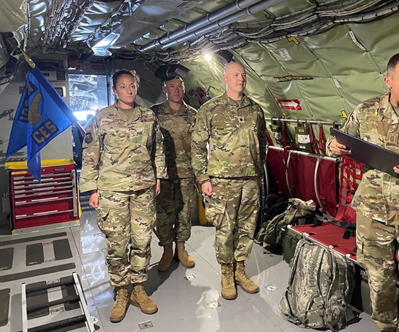 102nd Civil Engineer Squadron commander, Lt. Col. Christian Leighton, promotes Tech. Sgt. Morgan Marconi to the rank of Master Sgt. while in flight on the way to Montana to participate in this year’s Air National Guard Civil Engineer Innovative Readiness Training.