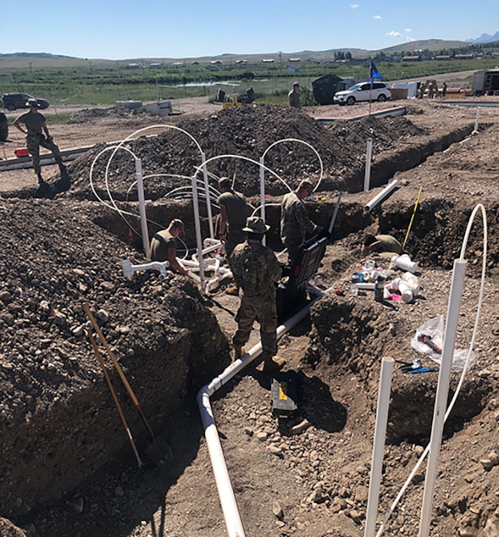 Several 102nd Civil Engineer Squadron Airmen perform plumbing work while deployed to this year’s Air National Guard Civil Engineer Innovative Readiness Training being held in Montana.