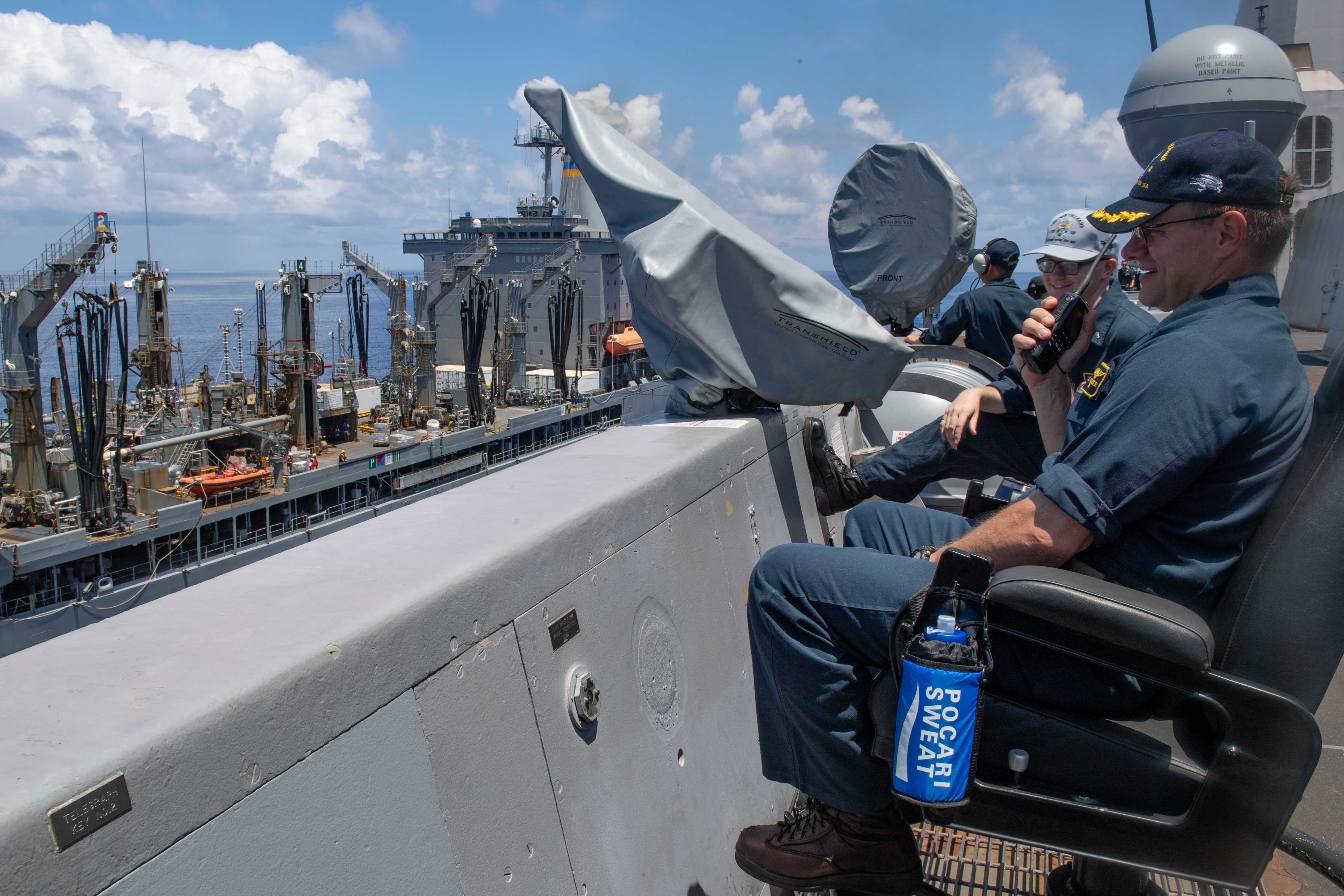 Capt. Douglas Graber oversees operations as the ship receives stores from the Military Sealift Command replenishment vessel USNS Rappahannock (T-AO-204) during a replenishment-at-sea.