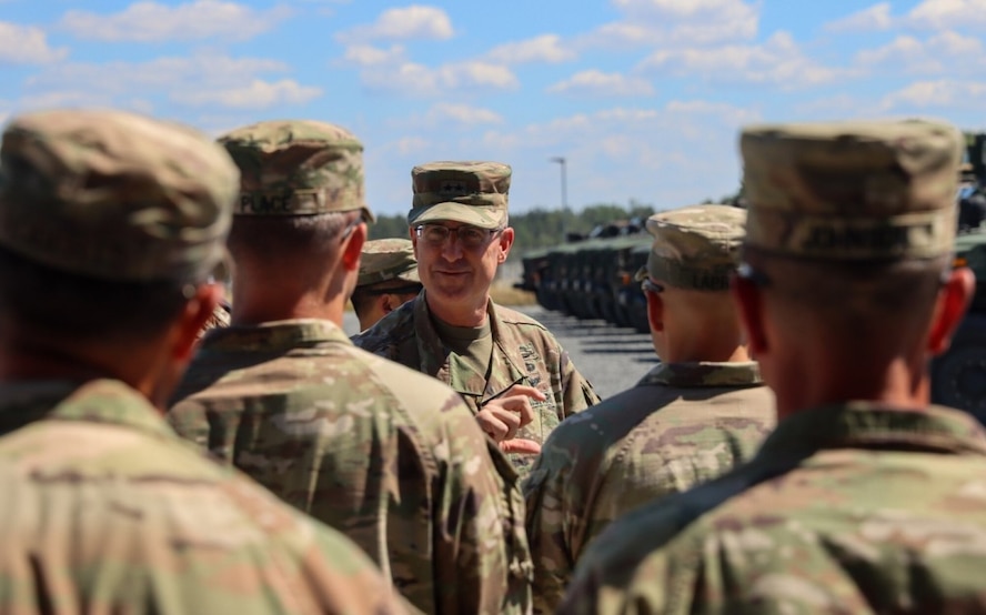 Army Maj. Gen. Robert Burke also received briefings at the turn-in site and watched Soldiers and civilians prepare hundreds of APS-2 heavy armored vehicles, transport trucks and equipment sets for turn-in, Aug. 3, during his visit to Grafenwoehr Training Area.
