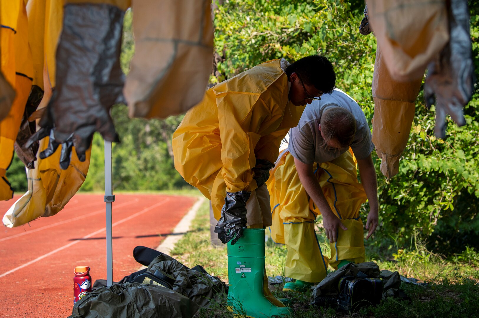 Medical Airmen put on their protective gear during a decontamination exercise June 23 at Eglin Air Force Base, Fla.  The chemical/biological exercise was part of required deployment training for Airmen medics.  More than 60 completed the three-day training course.  (U.S. Air Force photo/Samuel King Jr.)