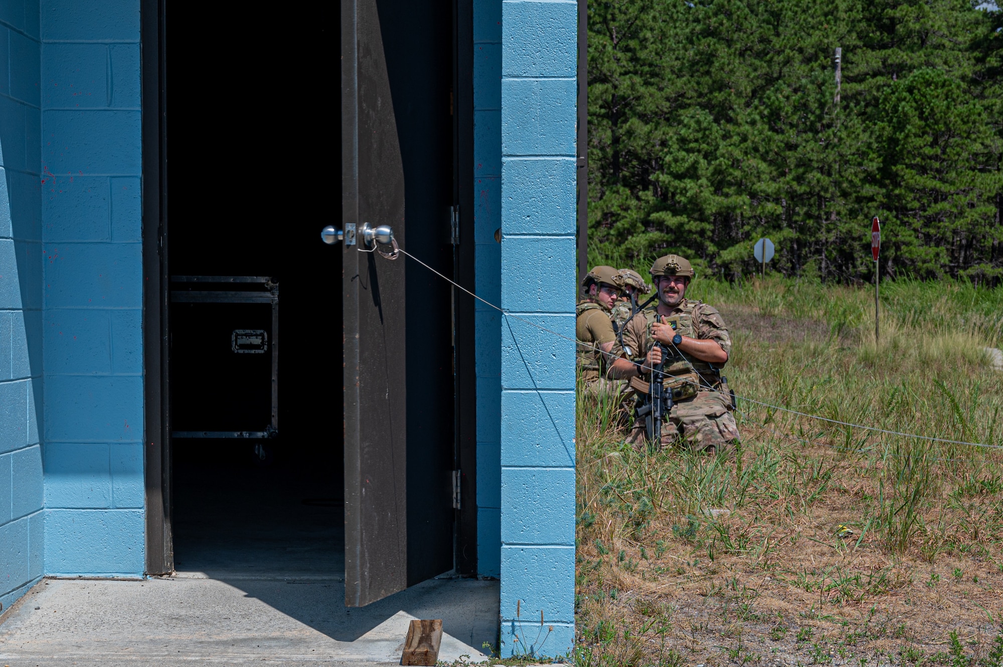 U.S. Air Force airmen safely open door during field training exercise.