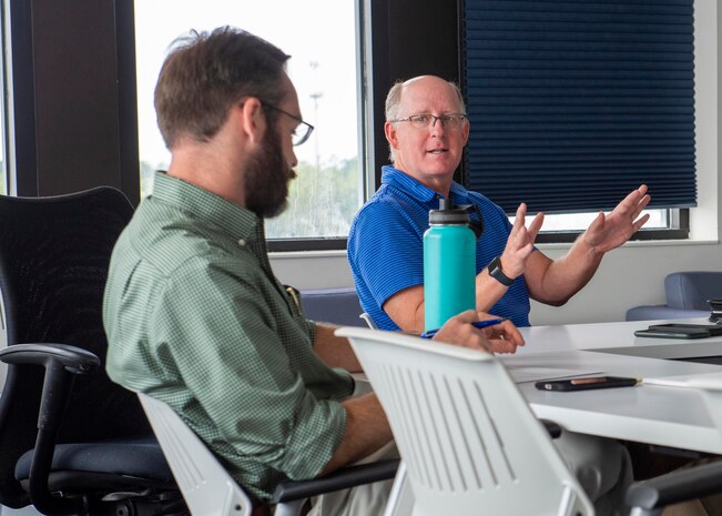 (right to left) Naval Surface Warfare Center Panama City Division (NSWC PCD) Prototyping Director for Mine Warfare Dr. Todd Holland discusses a submitted problem statement with Andrew Bouchard, NSWC PCD Center for Innovation (CFI) manager, during the Expeditionary Advanced Base Operations Concept Development Program Problem Statement Think Tank, June 10. CFI partnered with the review panel to help refine statements and also assist the selected submissions with an individual three-day design sprint. (U.S. Navy photo by Eddie Green)