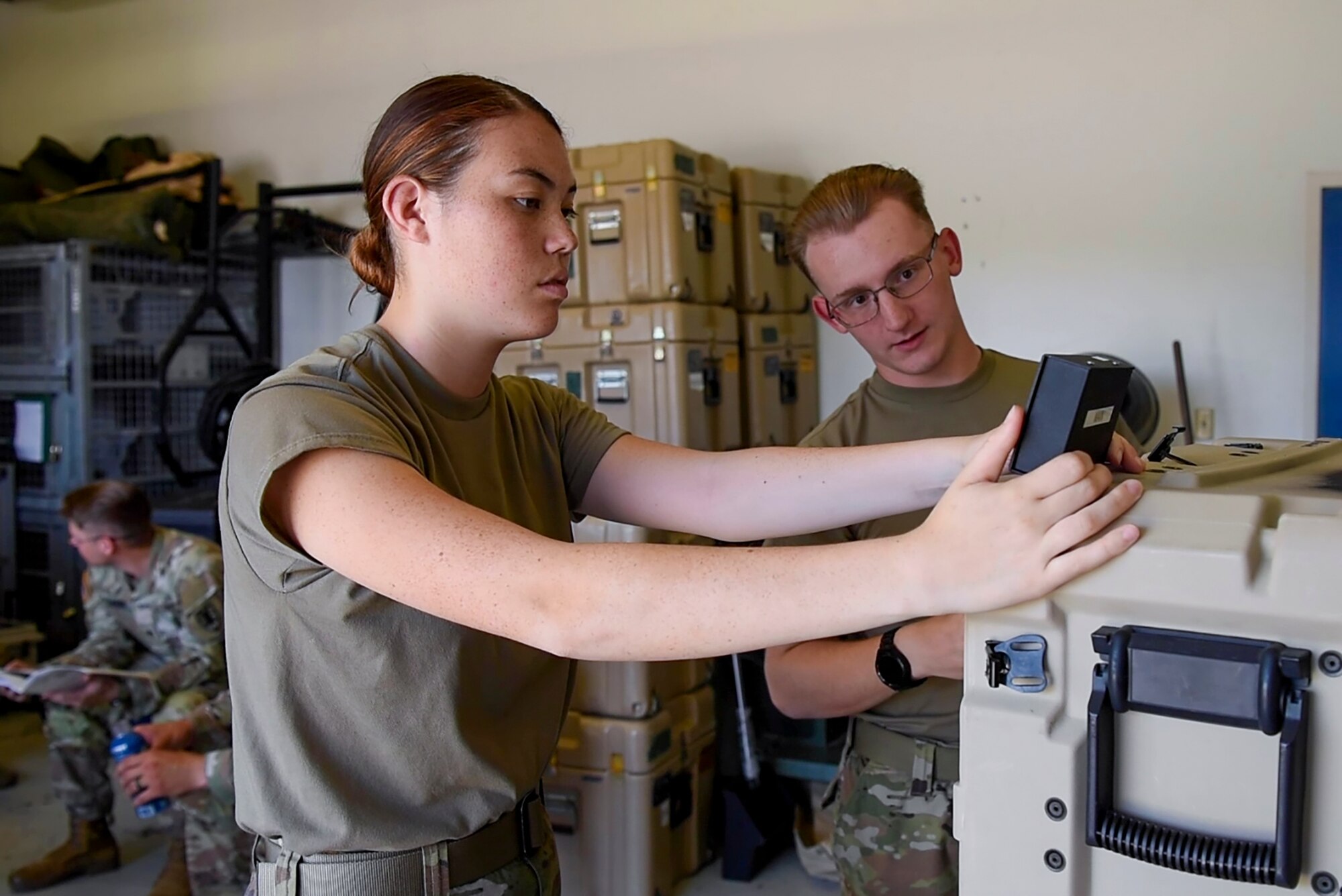U.S. Army Pfc. Vicky Evans and Pfc. Daniel Zink, 393rd Transportation Harbormaster Operations Detachment, 11th Transportation Battalion, conduct an operational test of the SIPR/NIPR satellite system at Joint Base Langley-Eustis, Virginia, Aug. 4, 2022.