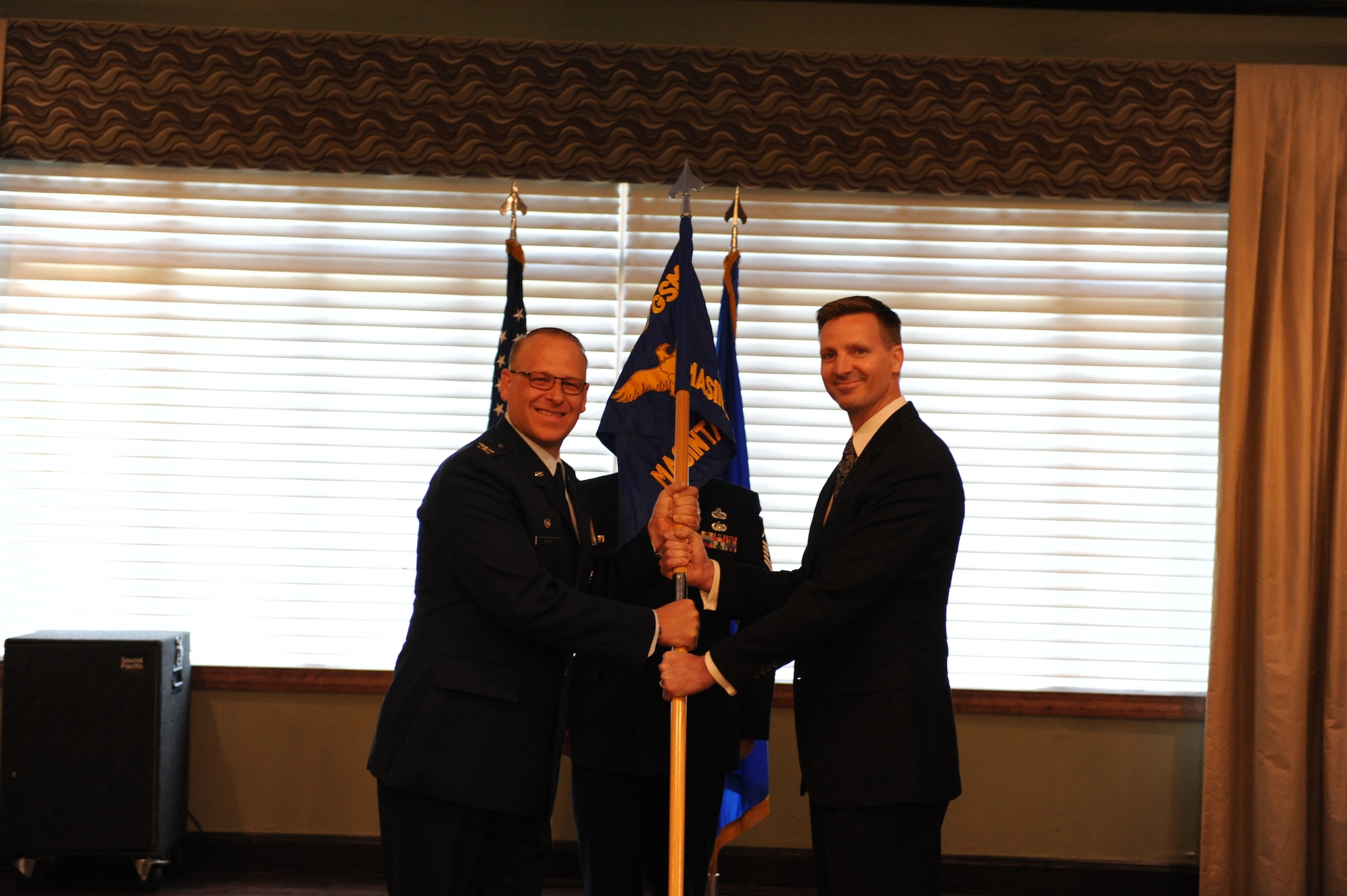 Jason McClurg accepts leadership of the Measurements and Signatures Intelligence Analysis squadron from Col. Steven Watts, Geospatial and Signatures Intelligence Group, at the Wright-Patterson Club, Wright-Patterson Air Force Base, Ohio, June 1, 2022. The MASINT Analysis squadron develops, operationalizes and leverages global sensors to collect, process, exploit and disseminate operationally relevant and responsive measurement and signature intelligence. (U.S. Air Force photo by Staff Sergeant Caleb House)