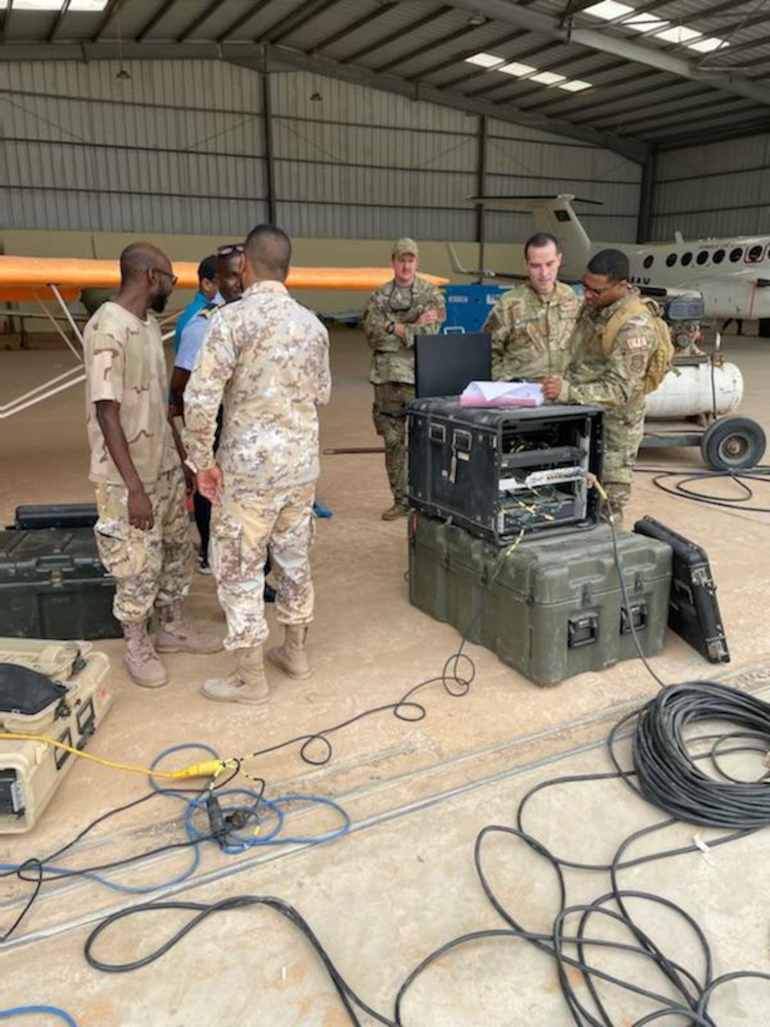 Members of the 818th Mobility Support Advisory Squadron assess ground intelligence, surveillance, and reconnaissance equipment before an air-to-ground communications exercise