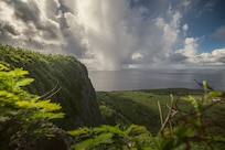 View of green cliff and ocean