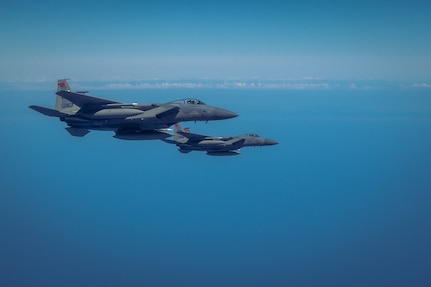 Pair of F-15 Eagle fighter jets fly beside KC-46