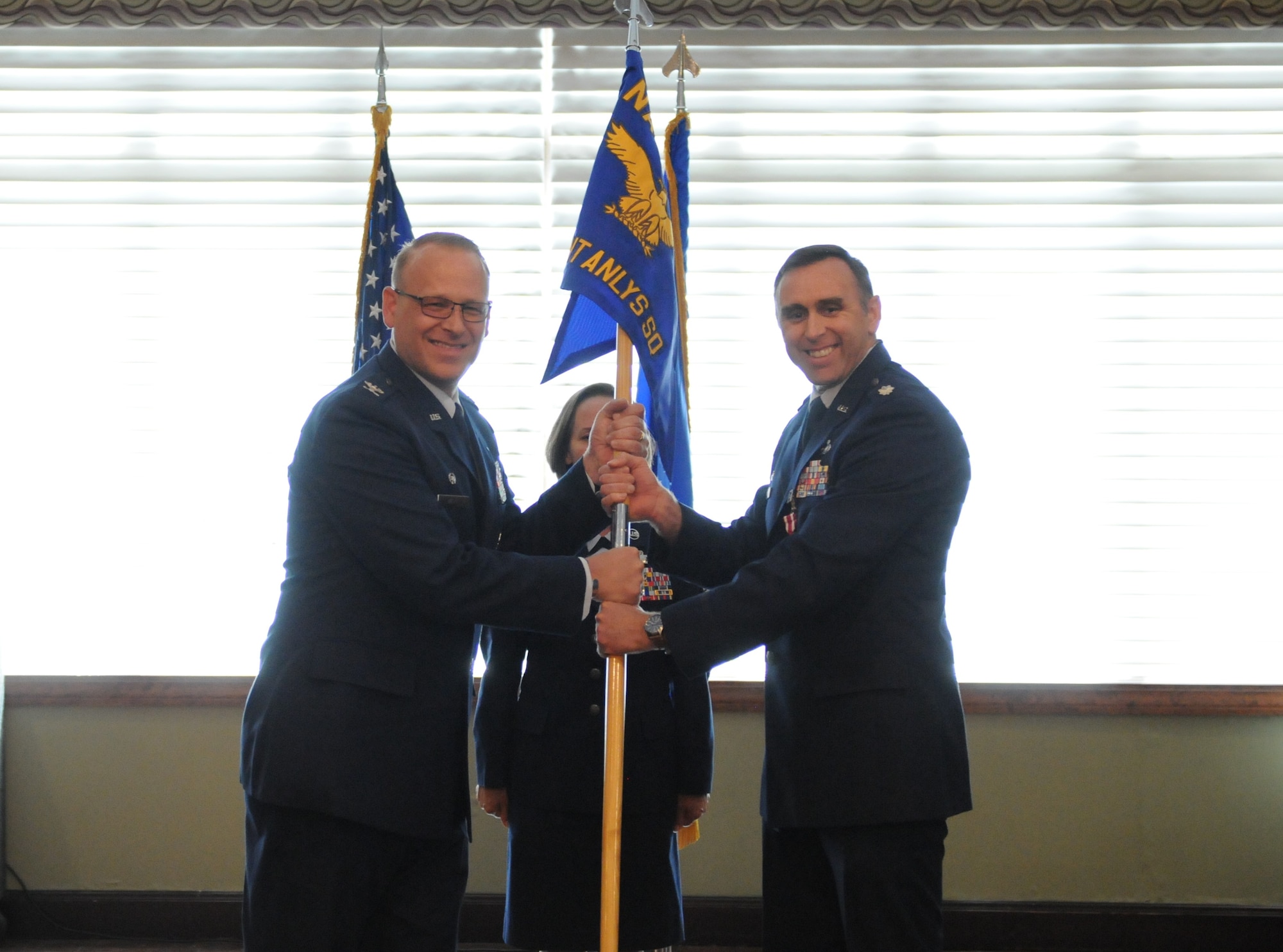 Lt. Col. Joseph Brown releases leadership of the Geospatial Intelligence Analysis squadron to Col. Steven Watts, Geospatial and Signatures Intelligence Group, at the Wright-Patterson Club, Wright-Patterson Air Force Base, Ohio, June 2, 2022. GSI creates tailored geospatially-based intelligence and capabilities to deliver decision advantage for the warfighter, policymaker, and weapon acquisition community. (U.S. Air Force photo by Staff Sergeant Caleb House)