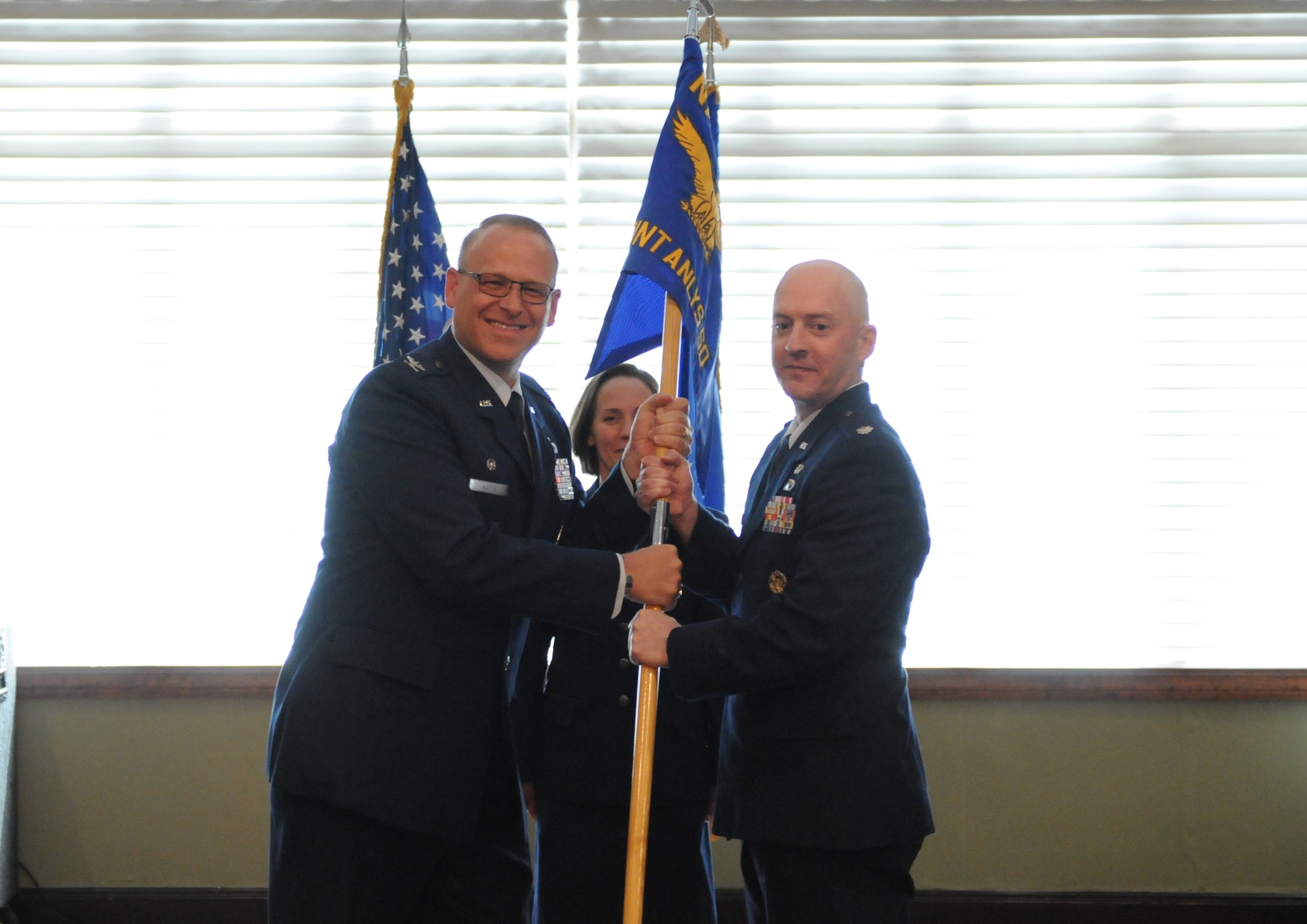 Lt. Col. Jason Seitz accepts command of the Geospatial Intelligence Analysis squadron from Col. Steven Watts, Geospatial and Signatures Intelligence Group, at the Wright-Patterson Club, Wright-Patterson Air Force Base, Ohio, June 2, 2022. GSI creates tailored geospatially-based intelligence and capabilities to deliver decision advantage for the warfighter, policymaker, and weapon acquisition community. (U.S. Air Force photo by Staff Sergeant Caleb House)