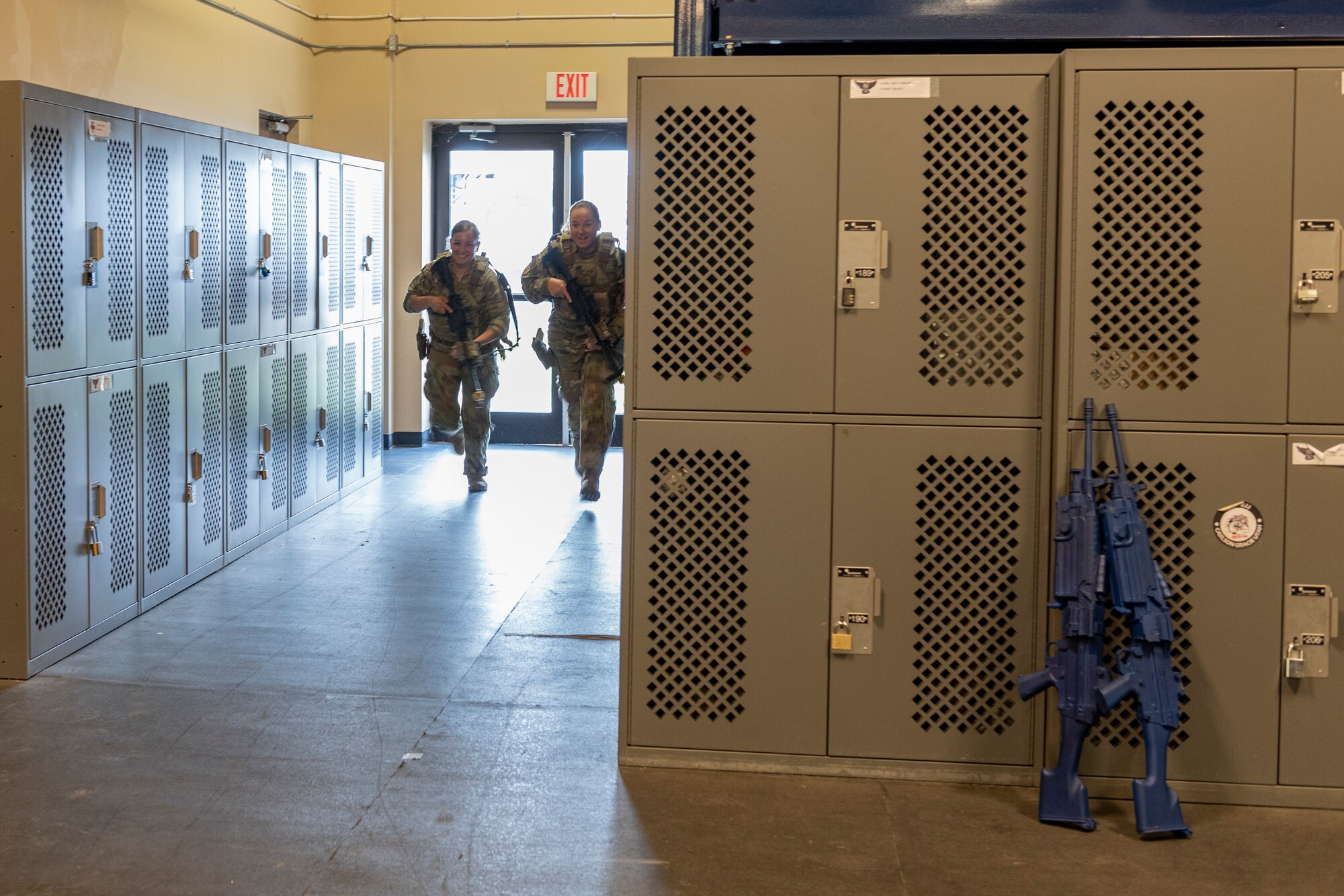 Photo of two Airmen performing a sprint drill