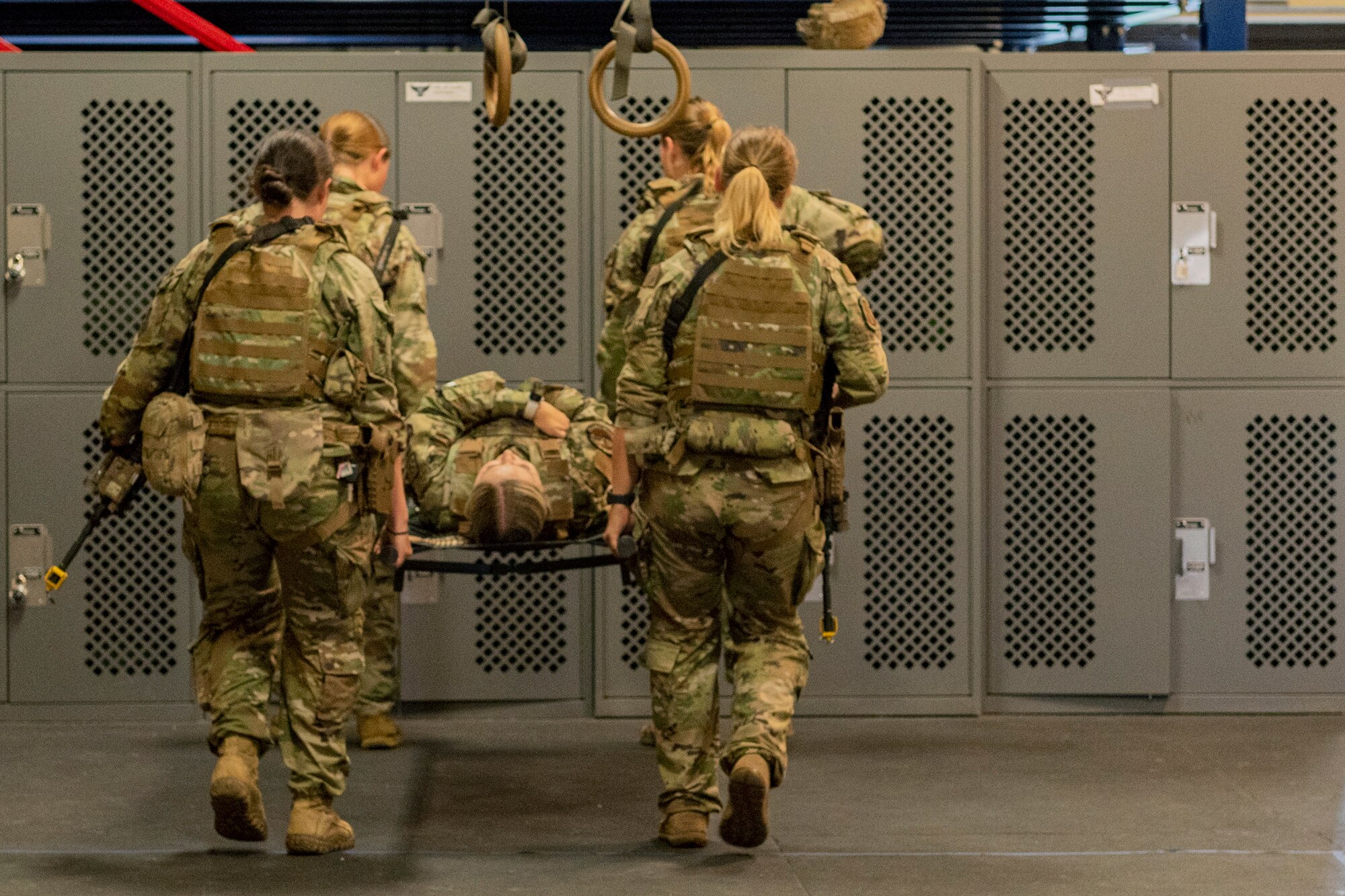 Photo of Airmen performing a litter carry drill