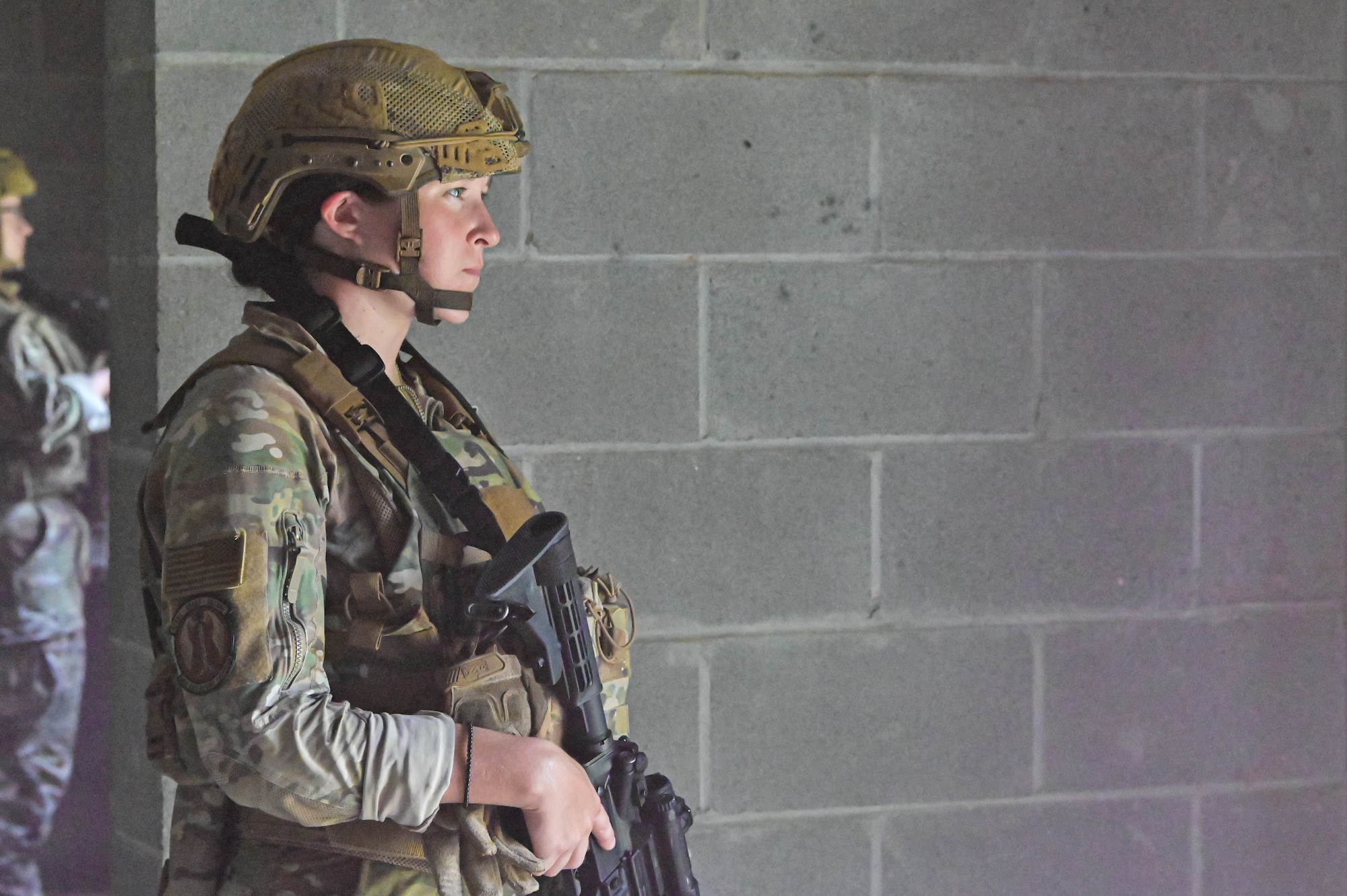 Photo of an Airman posting next to a door