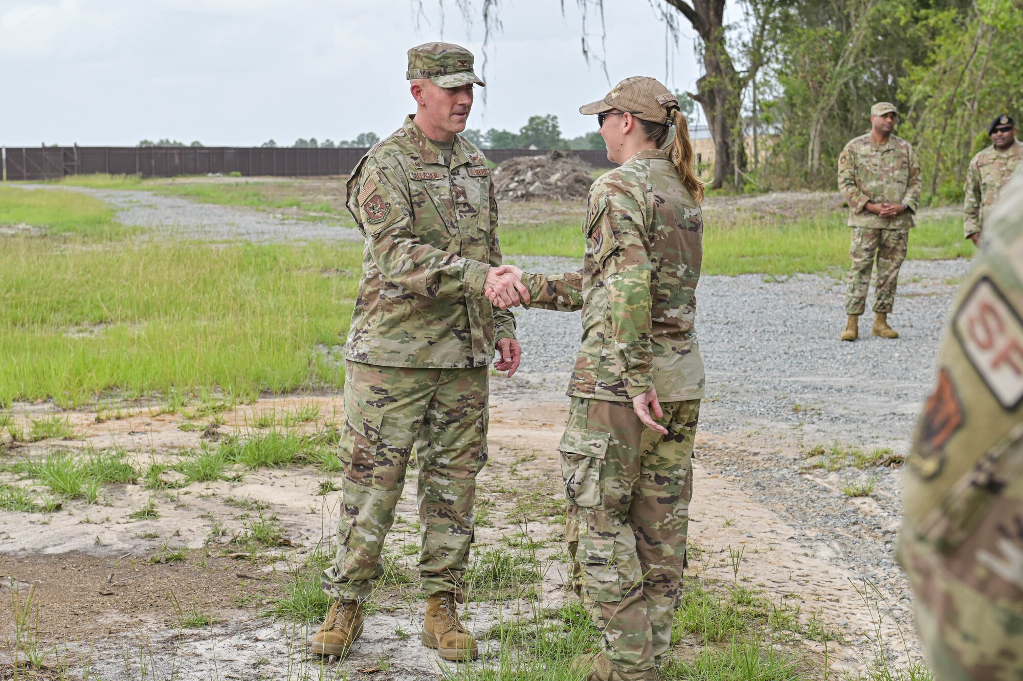 Photo of an Airman recognizing another Airman