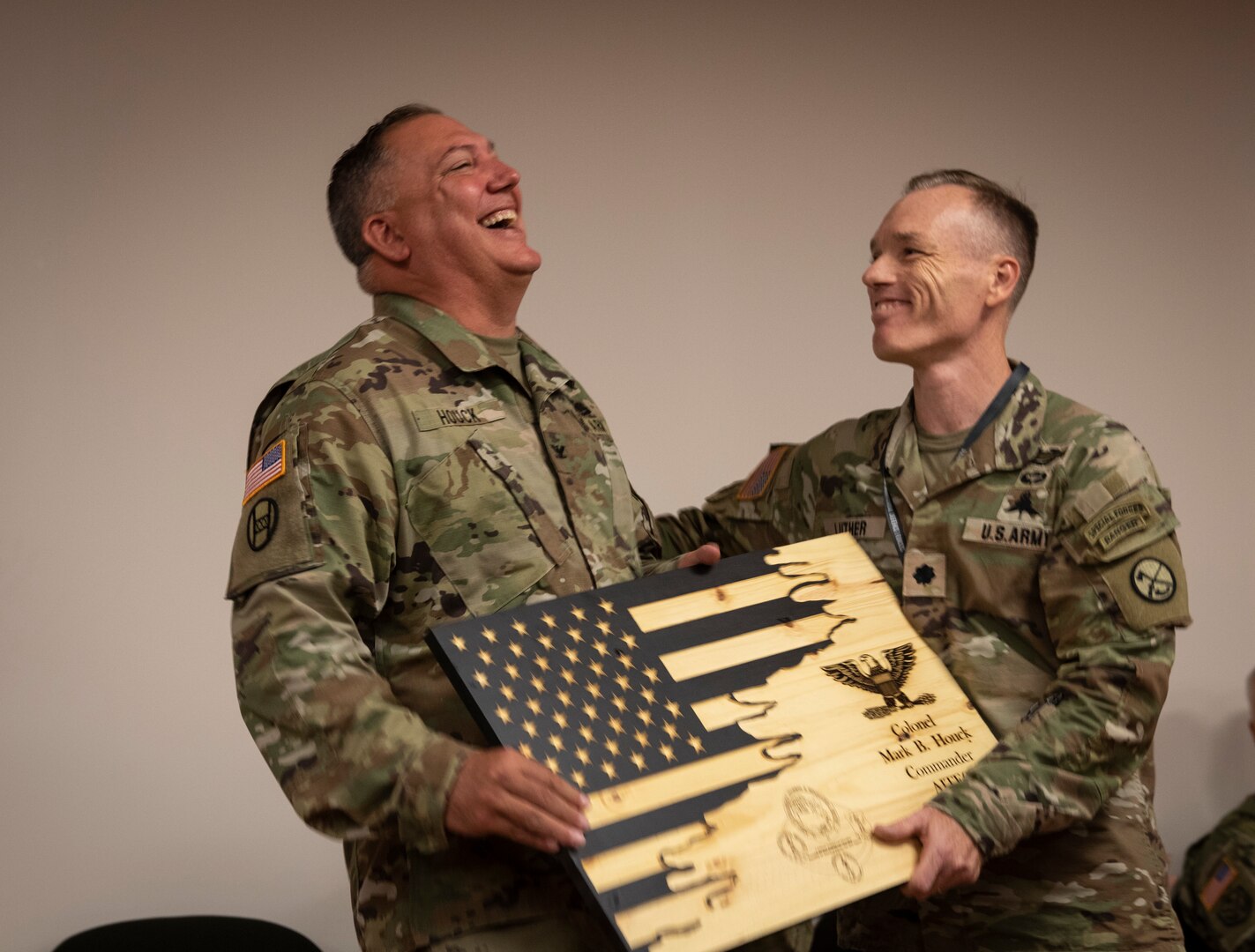 West Virginia Army National Guard Col. Mark B. Houck receives a gift of appreciation for his time as commander of the Army Interagency Training and Education Center (AITEC) from Lt. Col. Robert Luther during a ceremony at AITEC headquarters in St. Albans, West Virginia, Aug. 9, 2022. Houck relinquished command of AITEC to Lt. Col. Gina M. Nichols during the ceremony.
