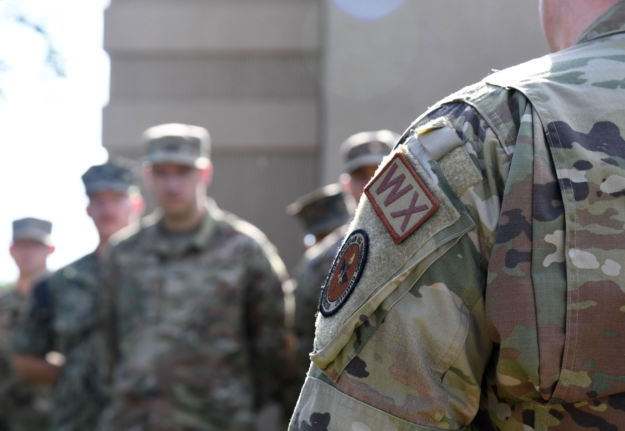 Students in the 335th Training Squadron gather for a weather training session outside of the Joint Weather Training Facility at Keesler Air Force Base, Mississippi, July 21, 2022. The weather apprentice course, which graduated 650 students this past year, takes 151 academic days to complete. Approximately 7,400 students go through the 335th TRS's 13 Air Force Specialty Codes each year. (U.S. Air Force photo by Kemberly Groue)