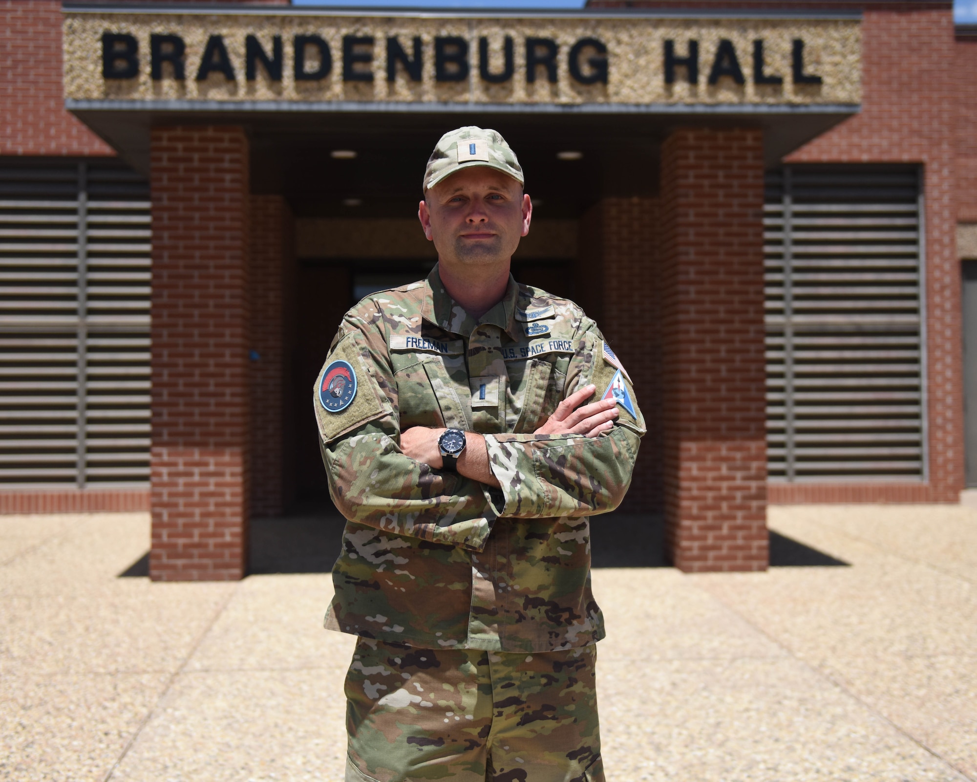 U.S. Space Force 1st Lt. Robert Freeman, 533rd Training Squadron Detachment 1 chief, poses for a photo in front of Brandenburg Hall at Goodfellow Air Force Base, Texas, Aug. 2, 2022. Freeman took responsibility of the 533rd TRS Det 1, June 21. (U.S. Air Force photo by Airman 1st Class Sarah Williams)