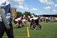 The Washington Commanders football team demonstrates various plays used in their games as service members and families watch at Joint Base Andrews, Md., Aug. 12, 2022.