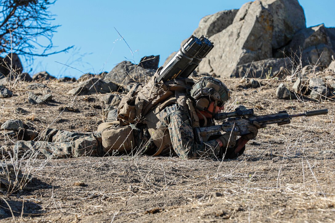 A U.S. Marine with Echo Company, 2nd Battalion, 1st Marine Regiment, 1st Marine Division, lies in the prone position on Range 800 at Marine Corps Base Camp Pendleton, California, Aug. 10, 2022. Range 800 is capable of hosting platoon attacks supported by rockets and machine guns, allowing 1st MARDIV units to conduct this type of training without traveling to another installation. (U.S. Marine Corps photo by Cpl. Harris)