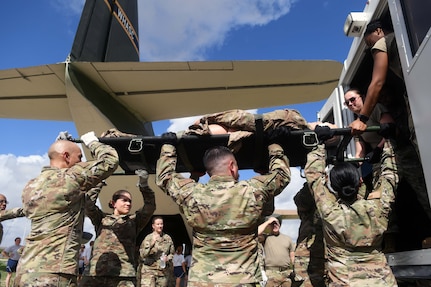 433rd Aeromedical Staging Squadron personnel lift a litter into the rear of an ambulatory vehicle during a ground patient movement training exercise at Joint Base San Antonio-Lackland, Texas, August 7, 2022. The exercise was the first for the ASTS since the start of the COVID-19 pandemic and allowed participants to practice procedures similar to loading and offloading a C-130 Hercules aircraft. (U.S. Air Force photo by Tech. Sgt. Mike Lahrman)