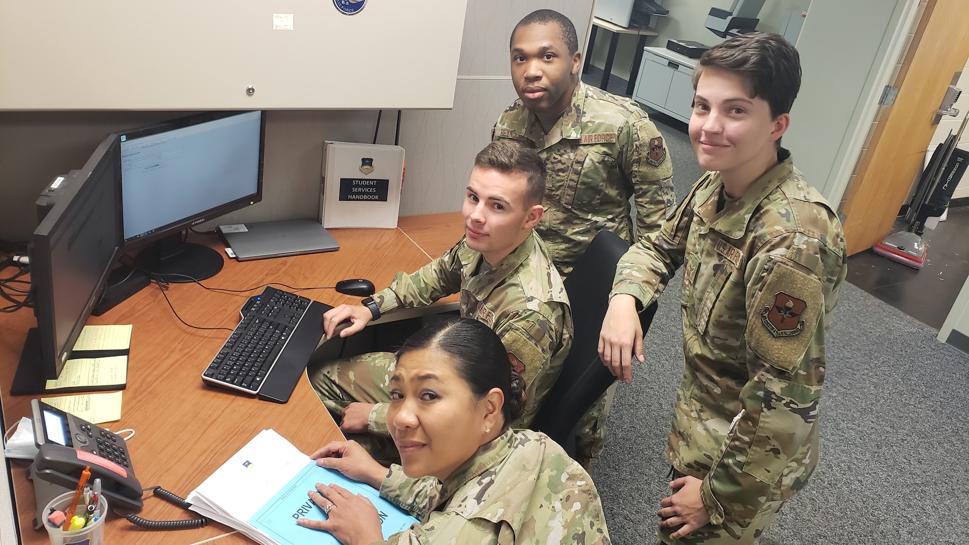 Members of the CCAF Student Services staff take a break for the camera while processing transcripts in the new electronic system. Members include (front to back): MSgt Ellainne Bay—Flight Chief; A1C Megan Dillingham, A1C Paul Phillips, and A1C Tywayne Reynolds. Not pictured is A1C Nathaniel Hernandez