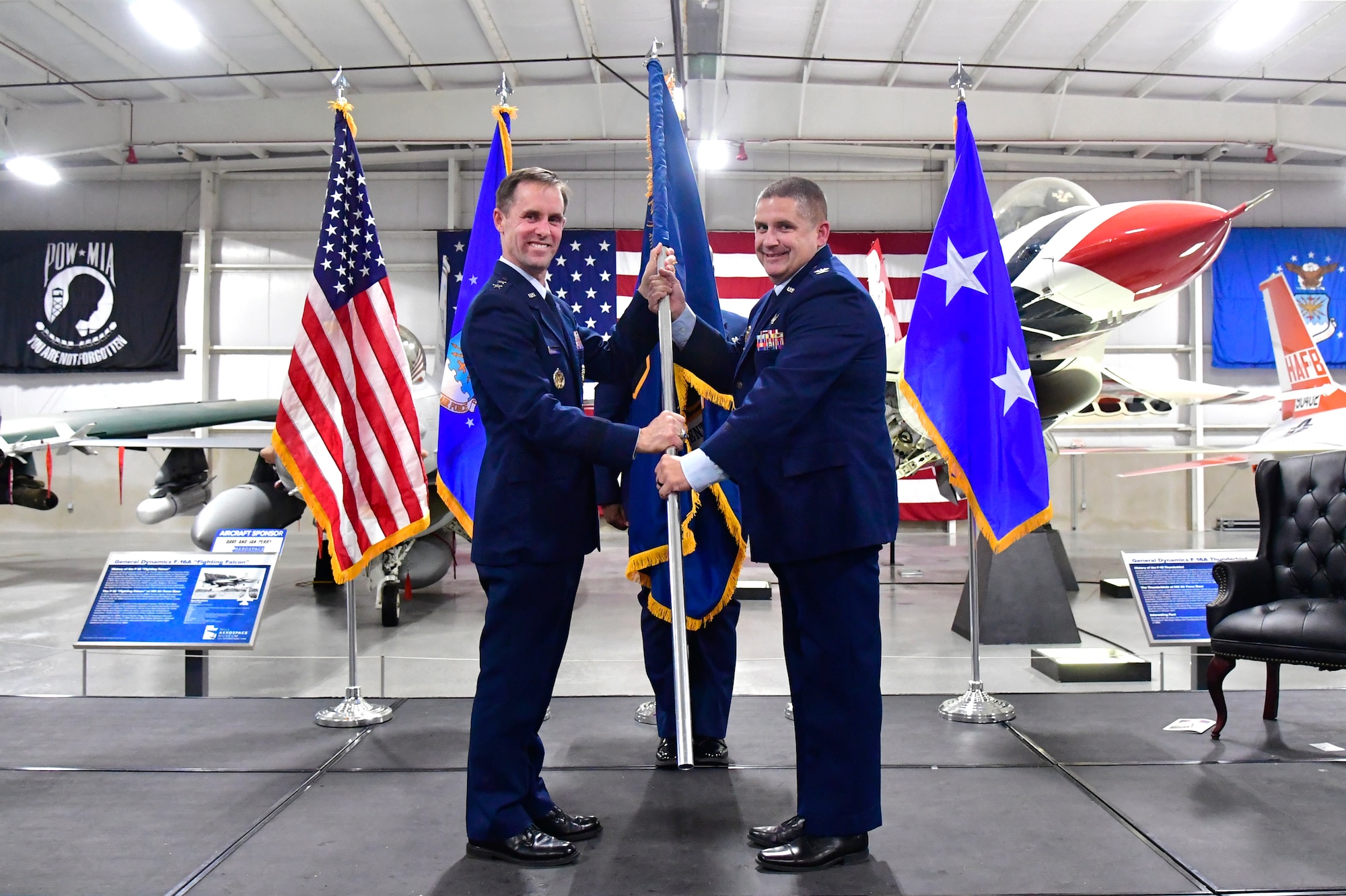 Maj. Gen. John Newberry (left), commander of the Air Force Nuclear Weapons Center, hands the directorate flag to Col. Charles Clegg, incoming director of the Sentinel Systems Directorate, during an assumption of responsibility ceremony July 27, 2022, at Hill Air Force Base, Utah. The direc-torate is responsible for the total life cycle of the new LGM-35A Sentinel intercontinental ballistic missile (ICBM), which will replace the LGM-30 Min-uteman III ICBM. (U.S. Air Force photo by Todd Cromar)