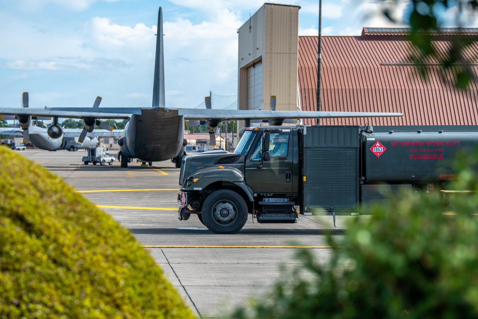 A C-130H Hercules with the French Air Force parks behind a R-11 fuel truck