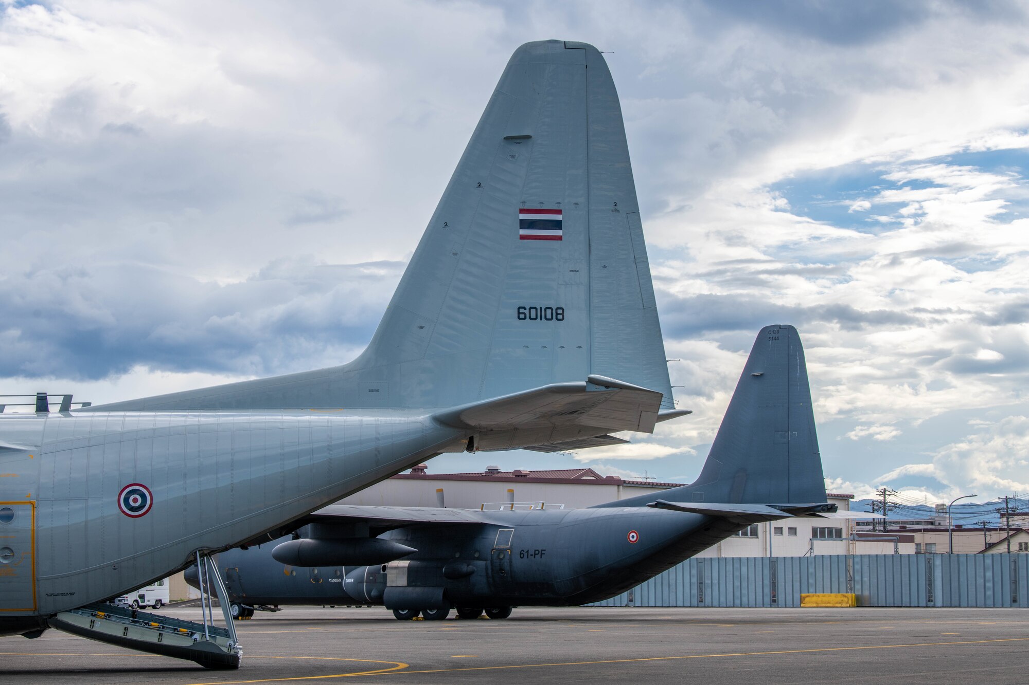 Two C-130H Hercules sit on a flightline